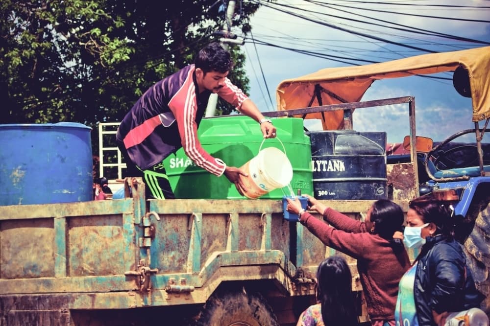 Women wait in line for clean water.