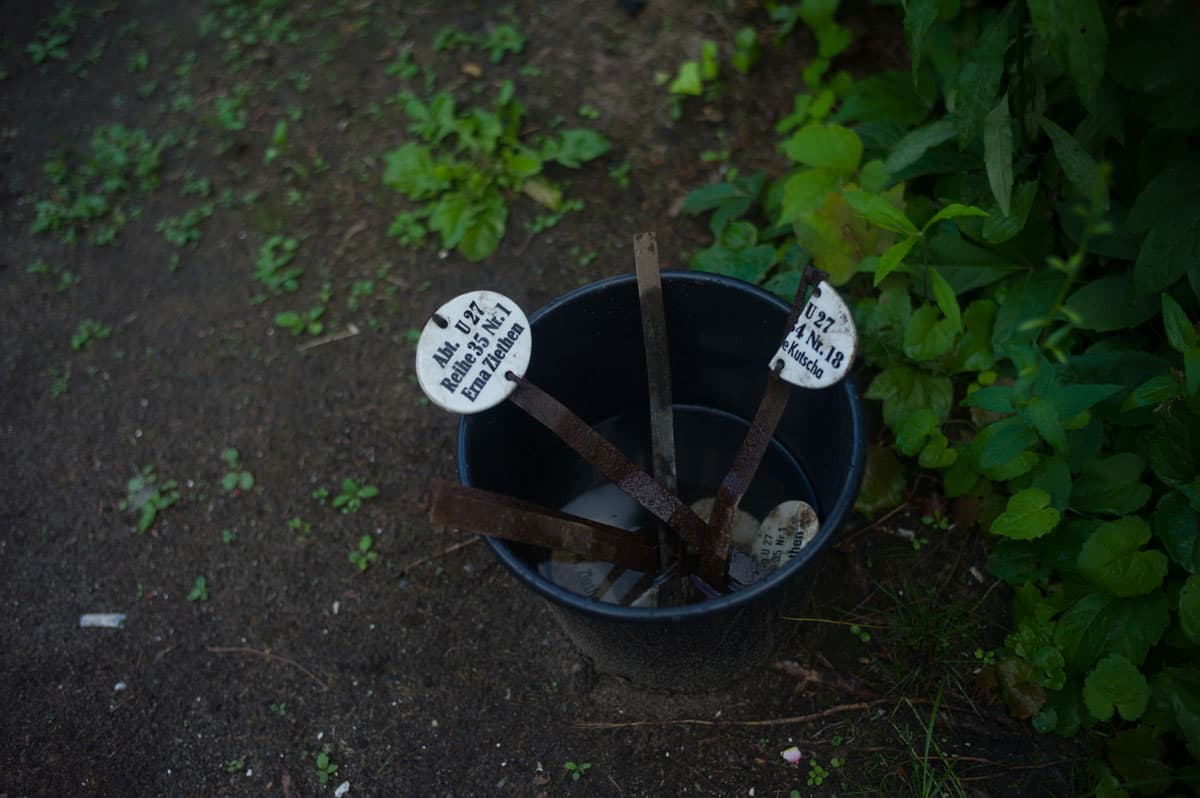 Retired grave markers sit outside the main office of “Die Gartnerei” project.