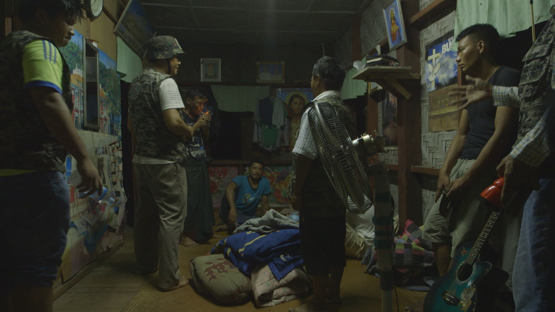 Vigilantes raid a home in Myitkyina to capture a man accused of smoking meth. Their target — La Seng, lighting a cigarette — is among thousands singled out by the anti-drug group Patjasan, which operates in Myanmar's north. A drug epidemic there has compe