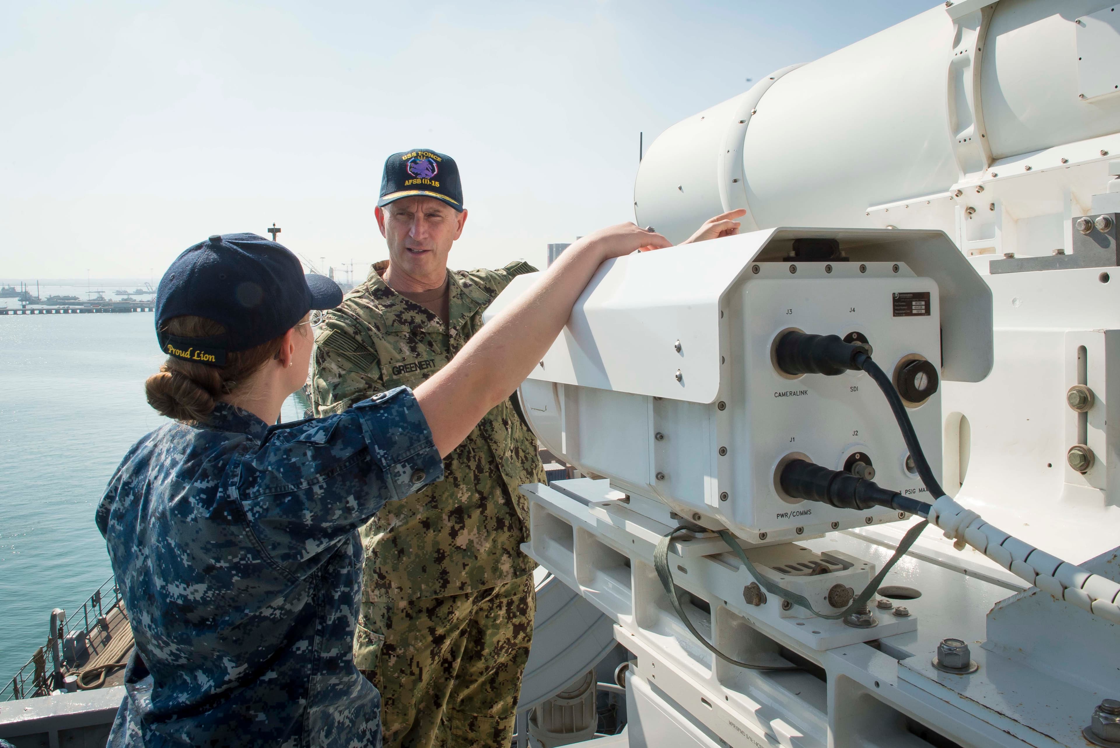 US Navy officers with the laser weapon on the USS Ponce.