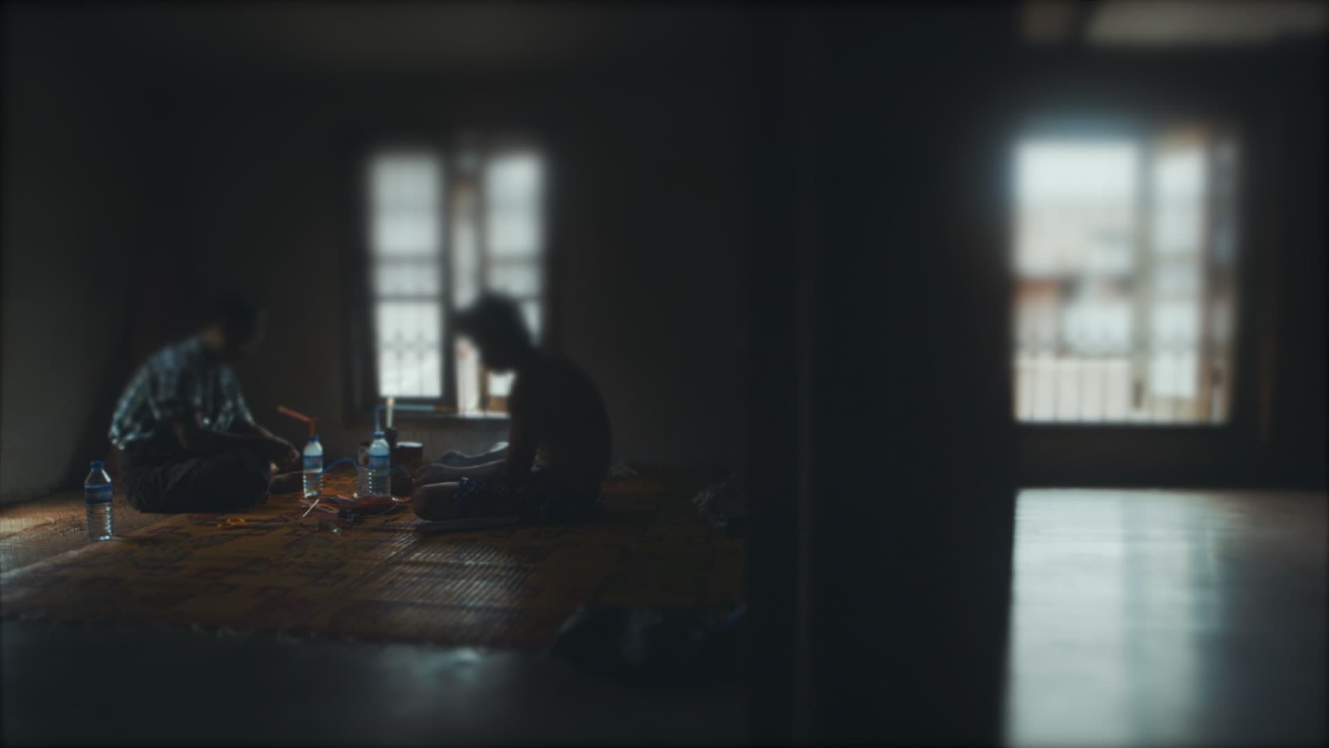 Meth users prepare a DIY water bong built from plastic bottles, pastel straws and foil in Myitkyina, Myanmar. Meth in Myanmar is trafficked by both anti-government rebels and pro-government militias. Their most popular product is pink, smokable tablets th