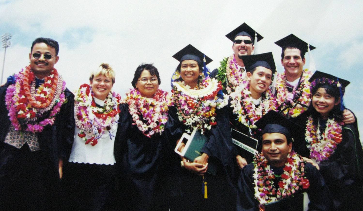 Graduates with leis