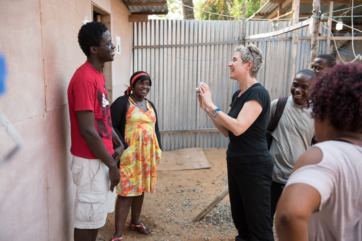 Mary Beth Heffernan taking photograph of health worker Morris Zolu.