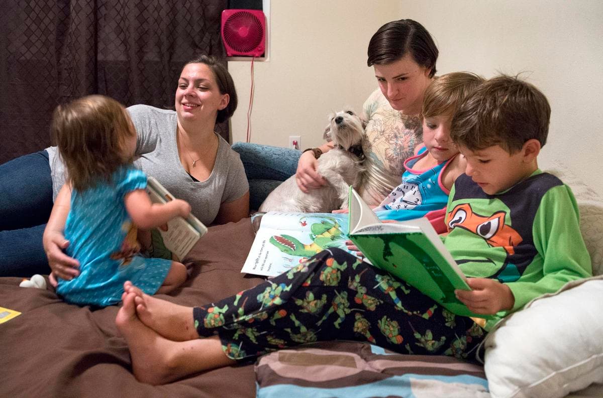 Capt. Jennifer Peace (center) at home with her wife Debbie and their children.