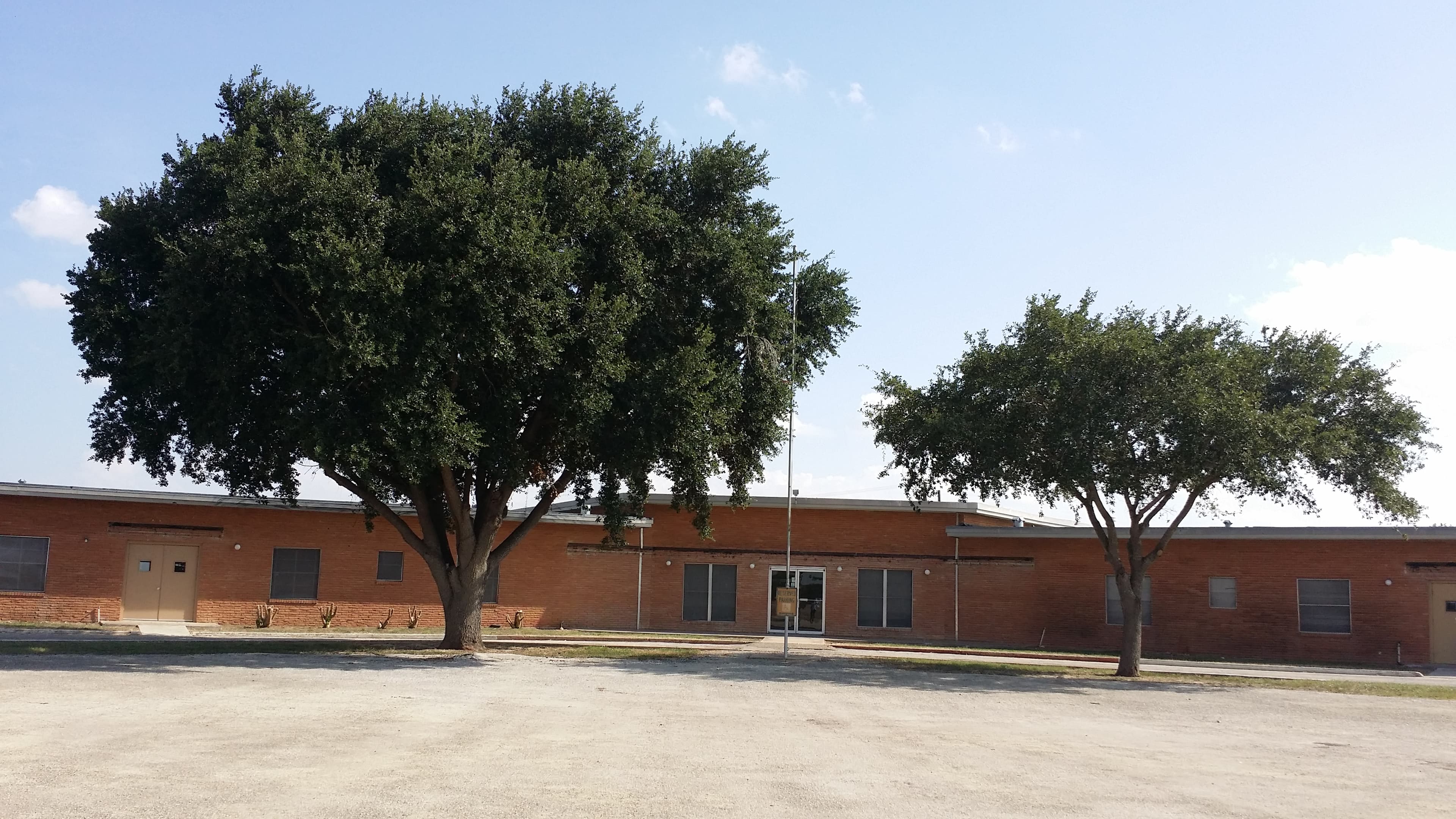 front of building, with trees