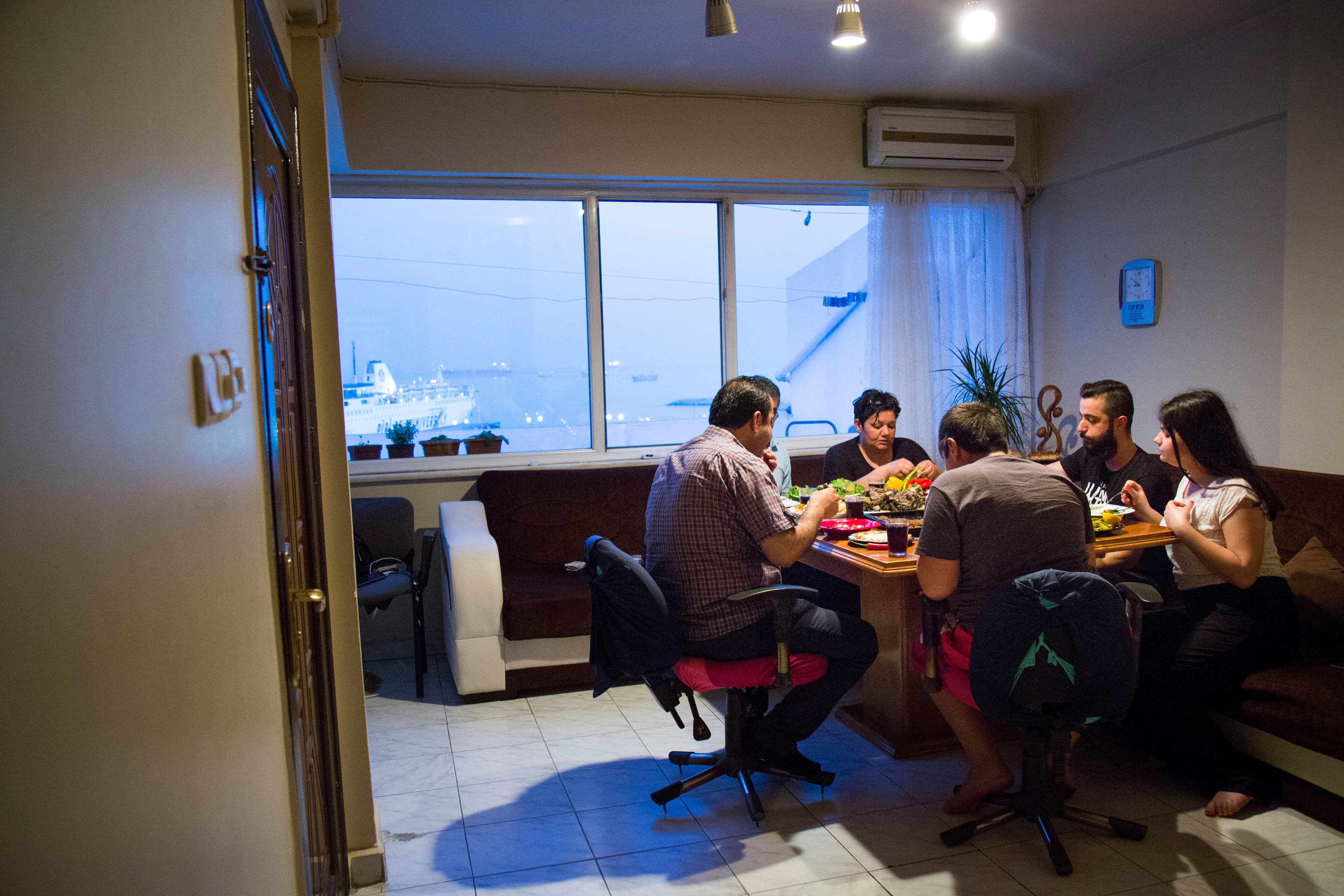 Nezmy, Souad, Jan and Loury share a meal with two friends from Syria during Ramadan.