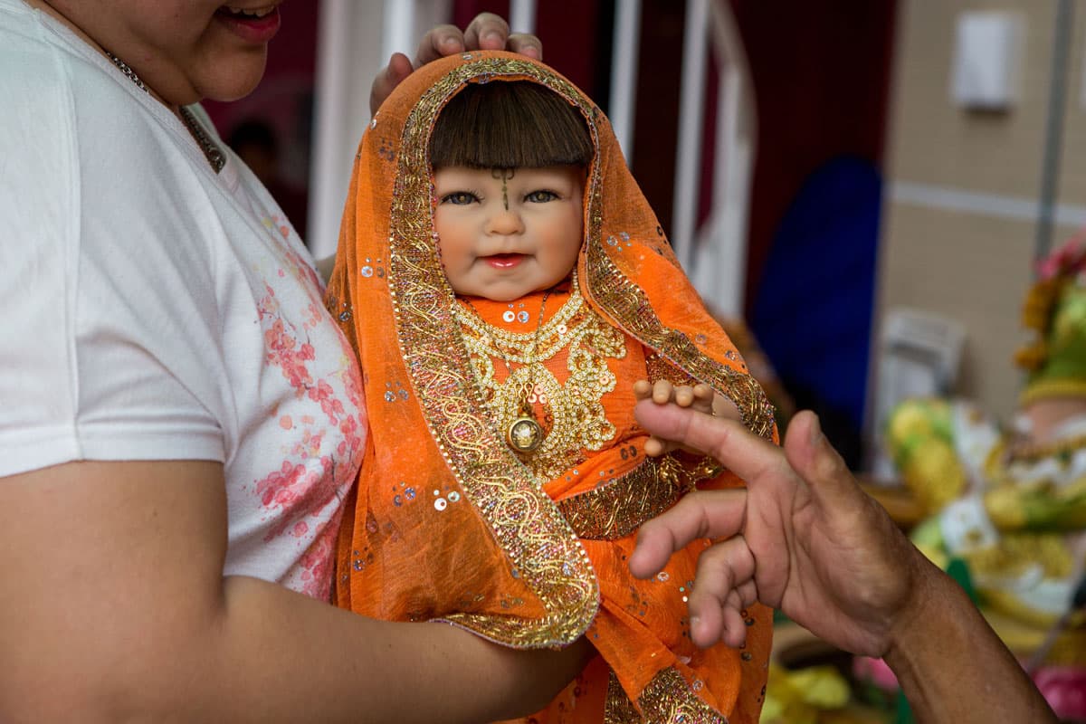 Luk Thep Yuri with her owners, a daughter and father.