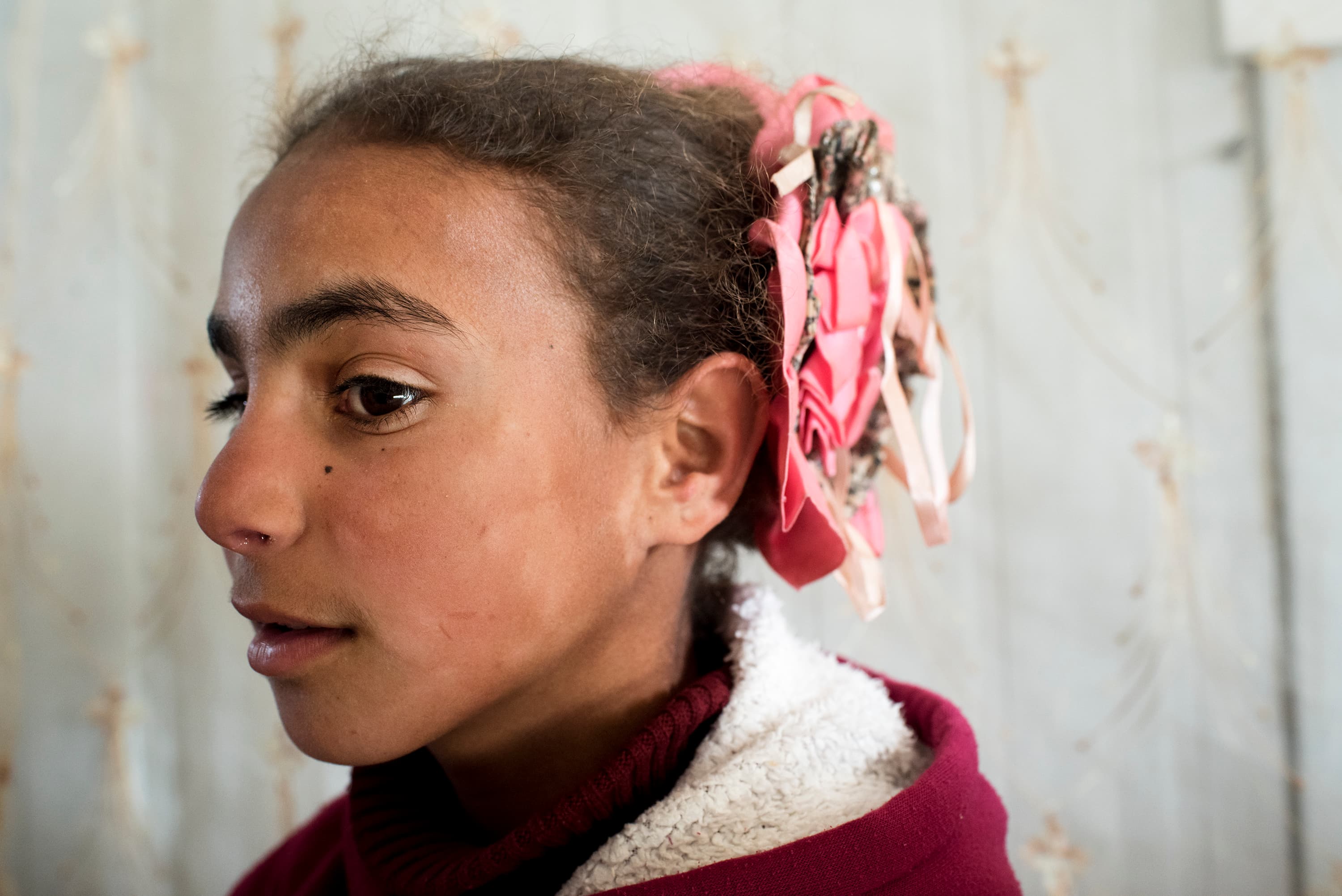 Um Ala's daughter Solana poses for a portrait inside the family's shelter. The 11-year-old has vivid memories of her life back in the family home in the outskirts of Daraa. 