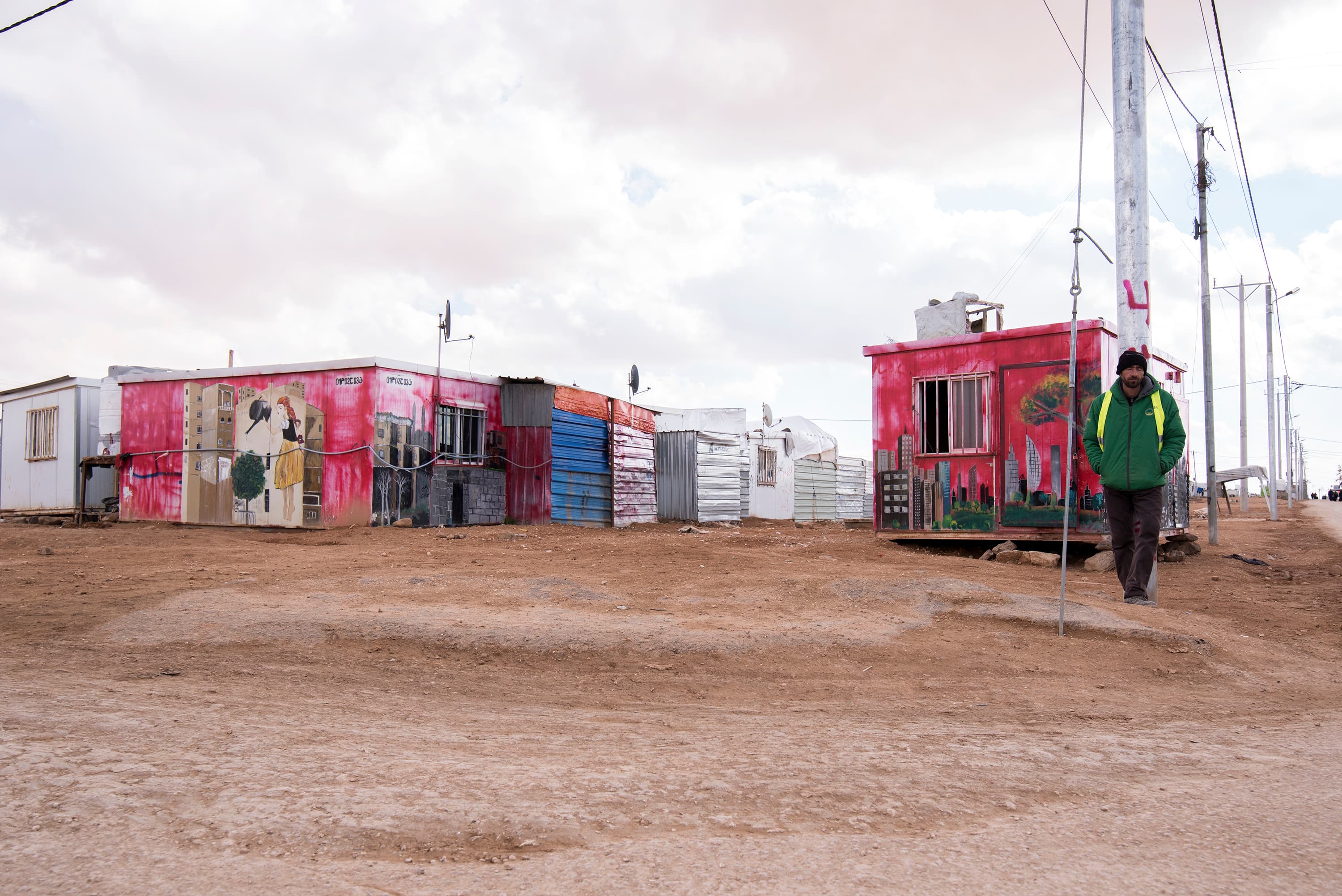 Murals adorn older metal shelters in the camp, part of art initiatives run by aid organizations for children in the camp.