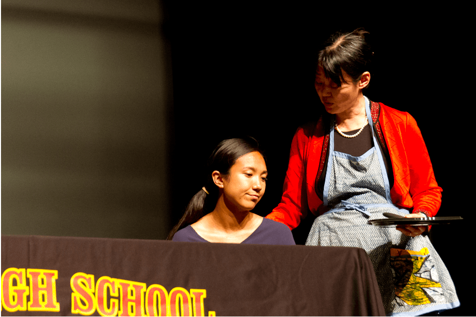 Hu places her hand on Nash's shoulder, on stage