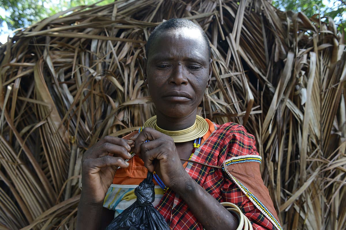 Udamugh, whose name means “waiting to heal,” fingers the yellow beads around her neck. She says she was forced to settle in Mkombani four years ago when park rangers from Mikumi National Park shot six of her cows, one by one, as she watched from inside he