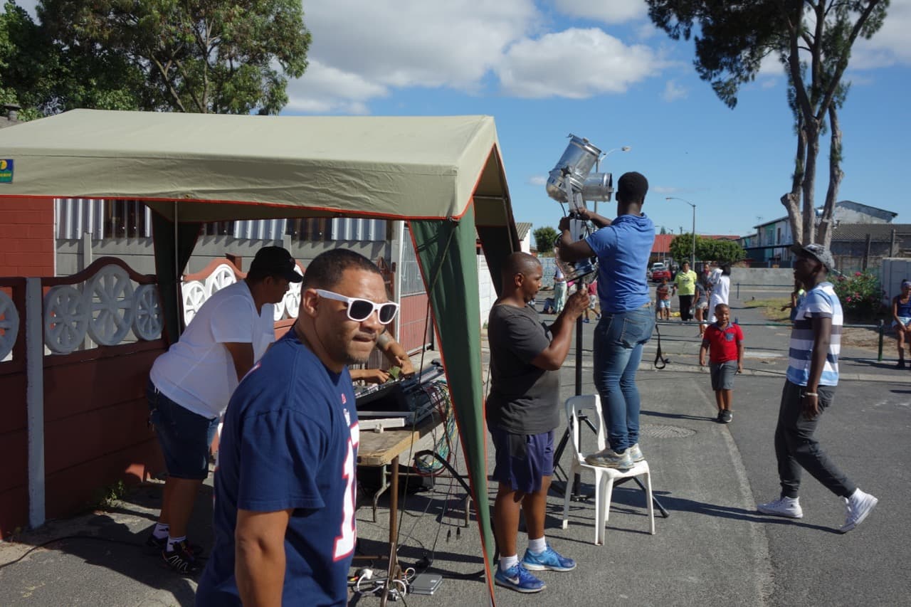 Brendan Adams, in sunglasses, helps set up for a concert in Elsie's River, near Cape Town in South Africa