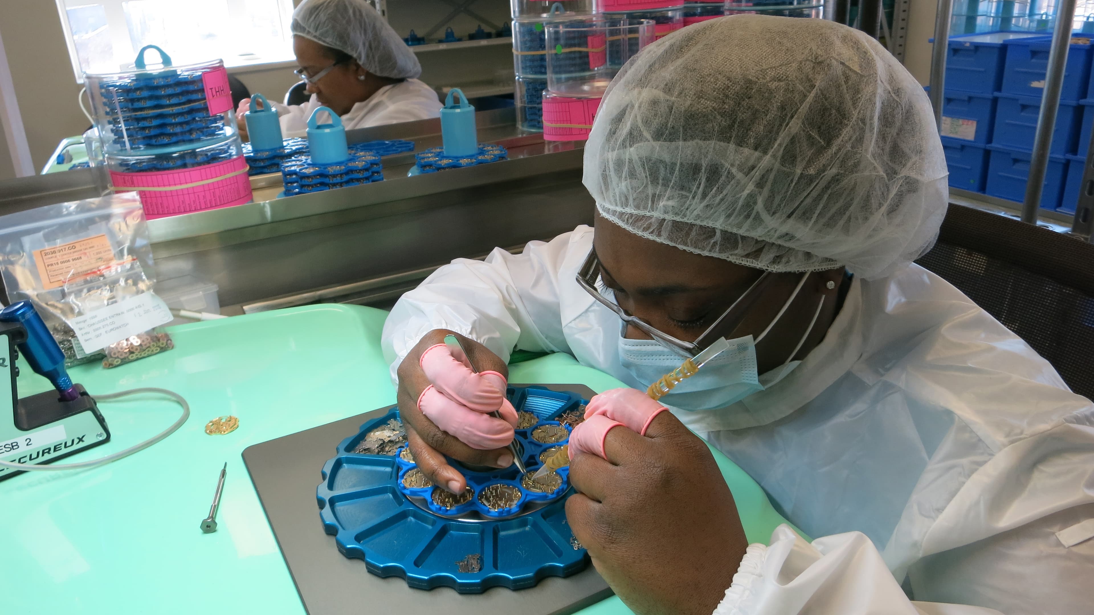 A worker assembles watches using tweezers in Shinola's factory in midtown Detroit.