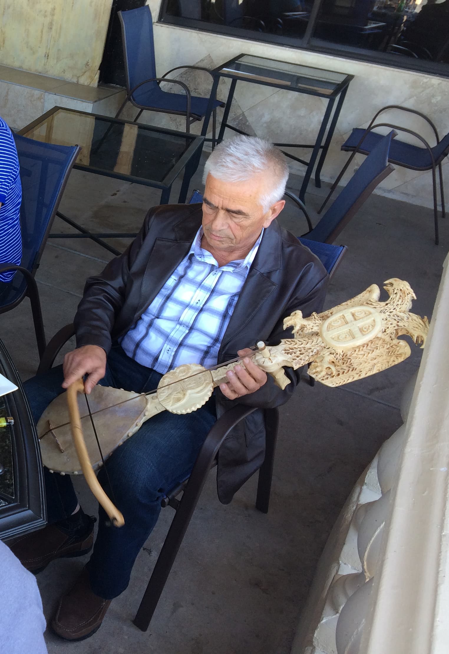 A patron at the Q2 Café in Phoenix plays the gusle.