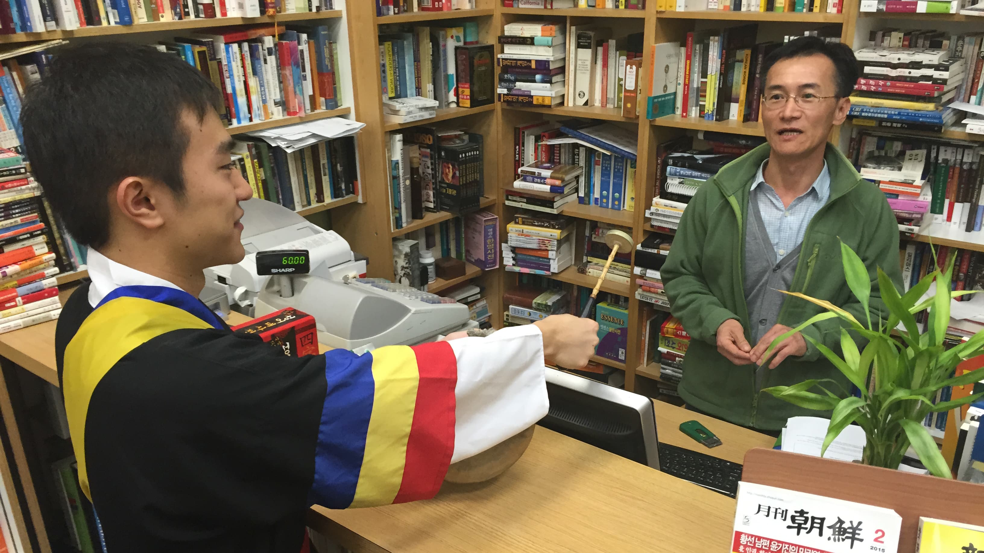 A bookstore owner in Koreatown gives the drummers good wishes for this new year.