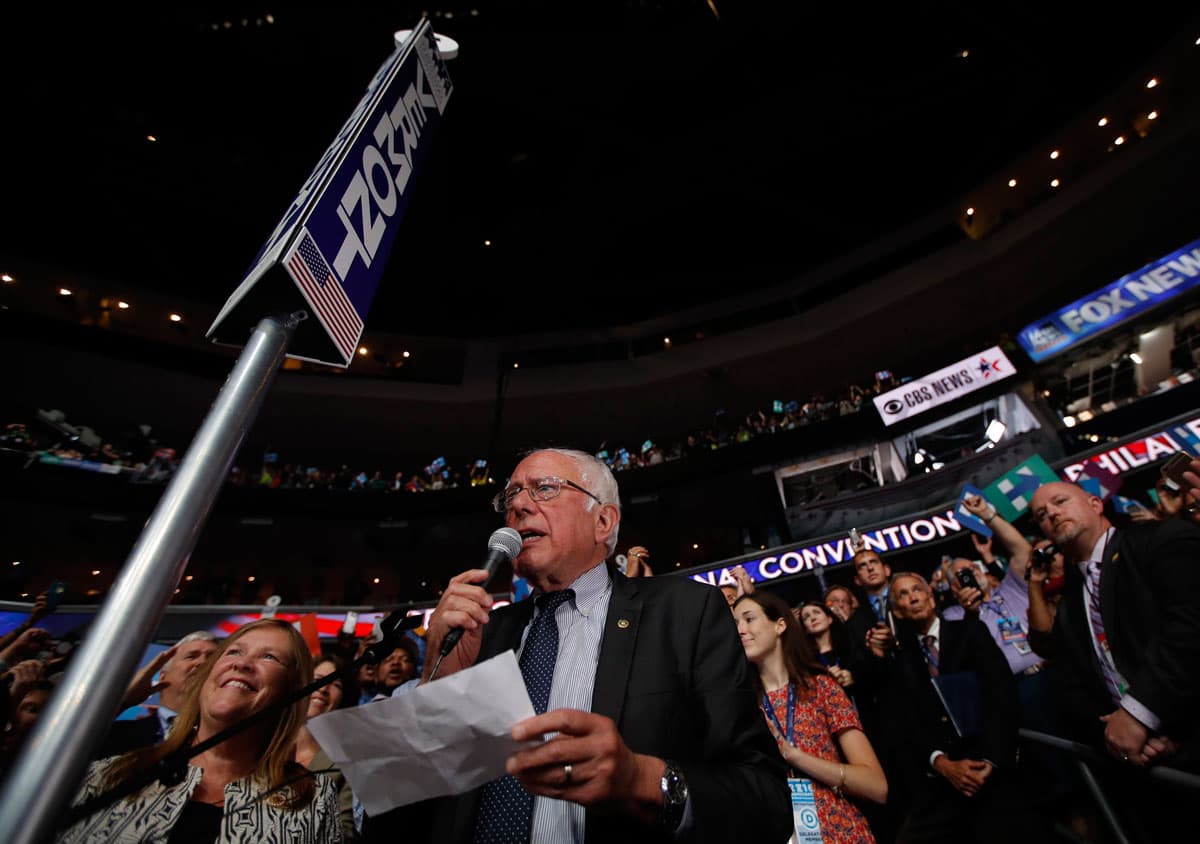 Former Clinton rival, Sen. Bernie Sanders, standing in the Vermont delegation with his wife Jane at his side, makes a motion to suspend the rules and nominate Hillary Clinton as the Democratic presidential nominee.