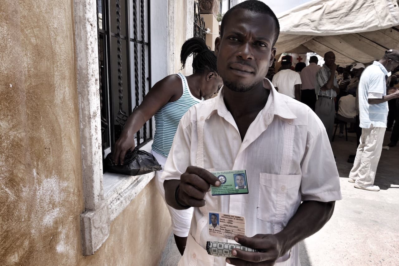 Jhonny Charles, a Haitian construction worker who's been in the Dominican Republic for 16 years, explains outside the Haitian Embassy in Santo Domingo, that the process of 