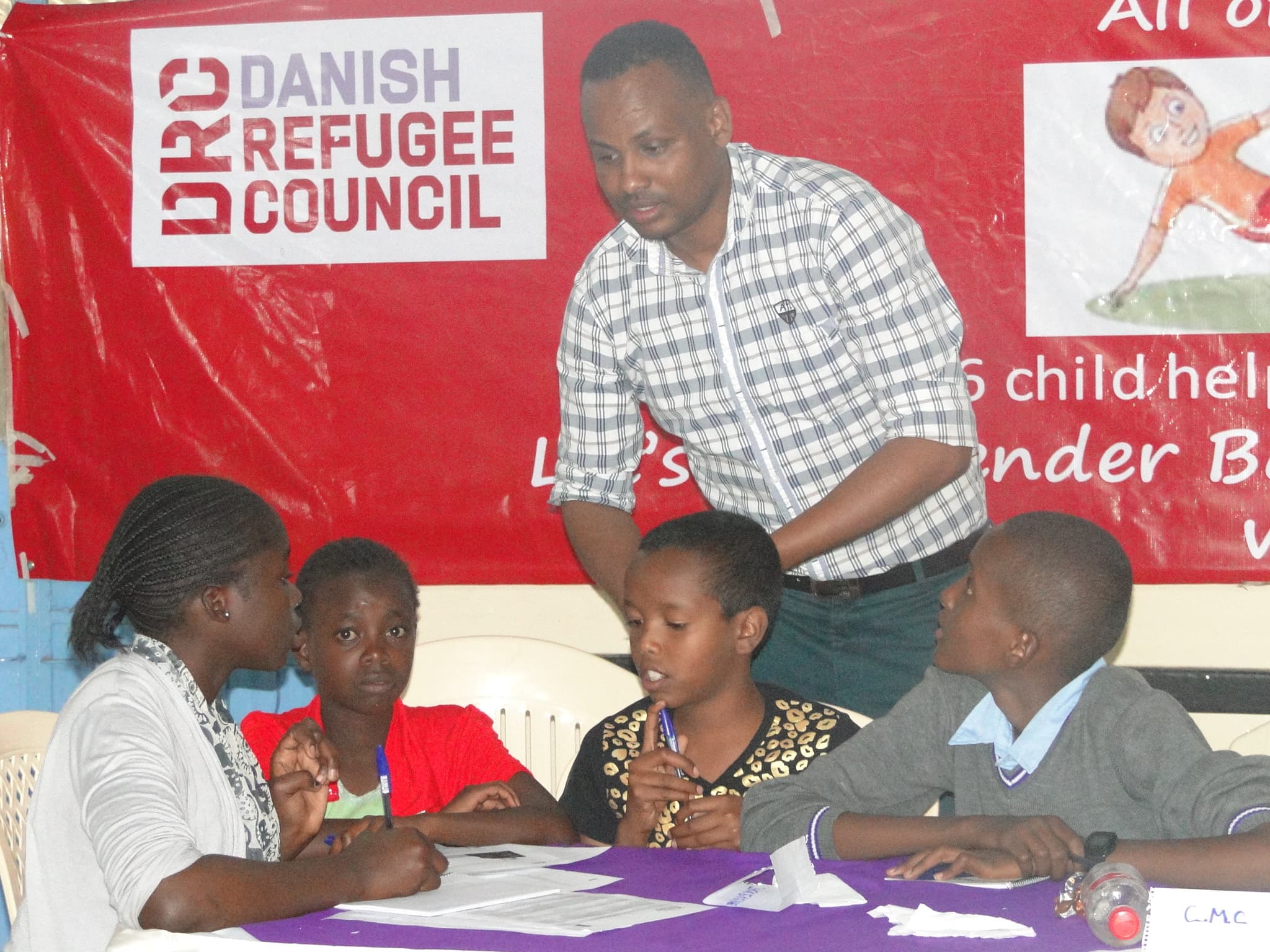 Fish's work with the Danish Refugee Council is considered volunteerism due to his refugee status.