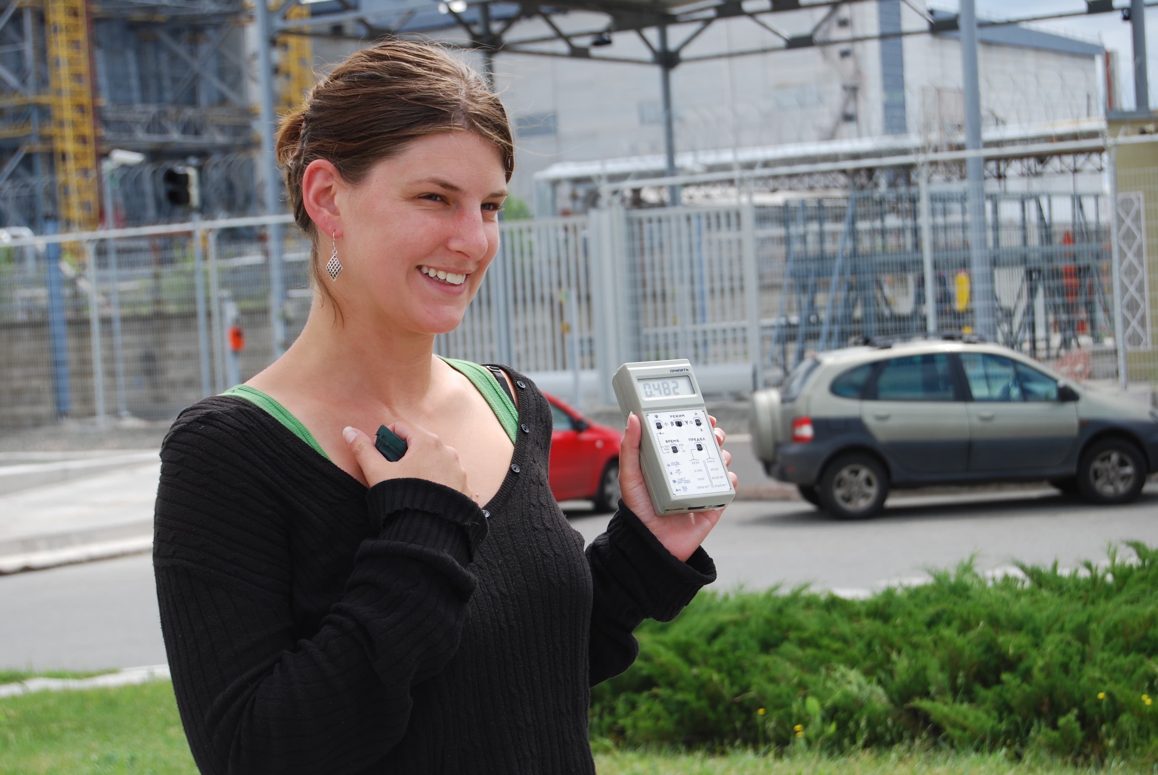An American tourist holds a Geiger counter, registering radiation, near the Chernobyl Nuclear Power Plant.