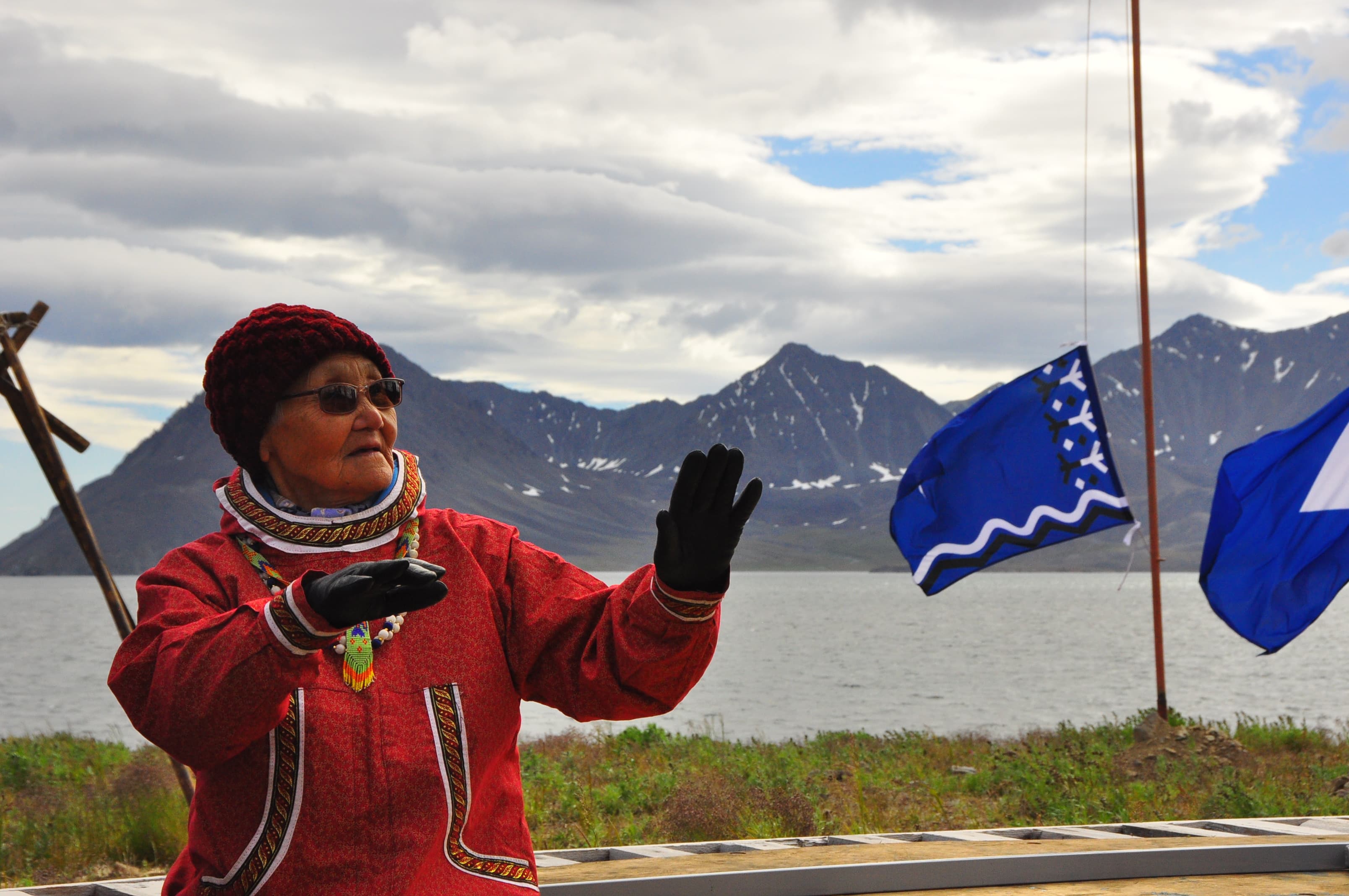 A village elder enjoys some of the singing and drumming during a break from the athletic events.