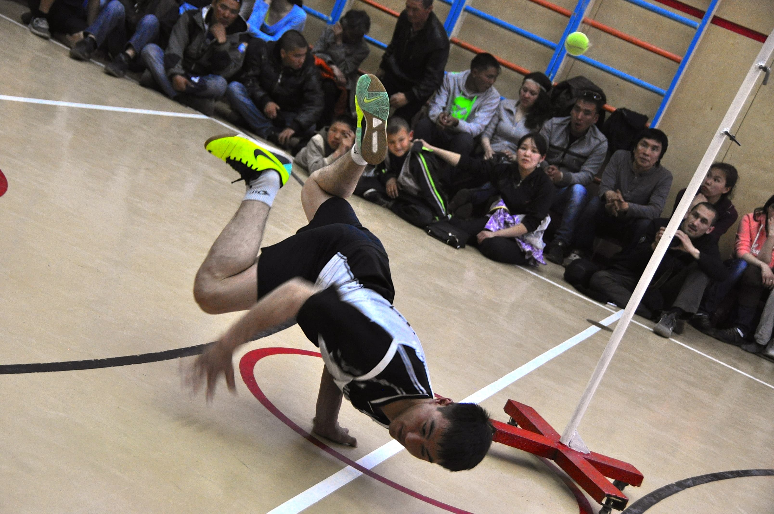 A Russian man competes in the one arm reach in the village of Novo Chaplino, where the games were hosted. This game is meant to mimic the motion one might make gathering bird eggs from a rocky cliff.