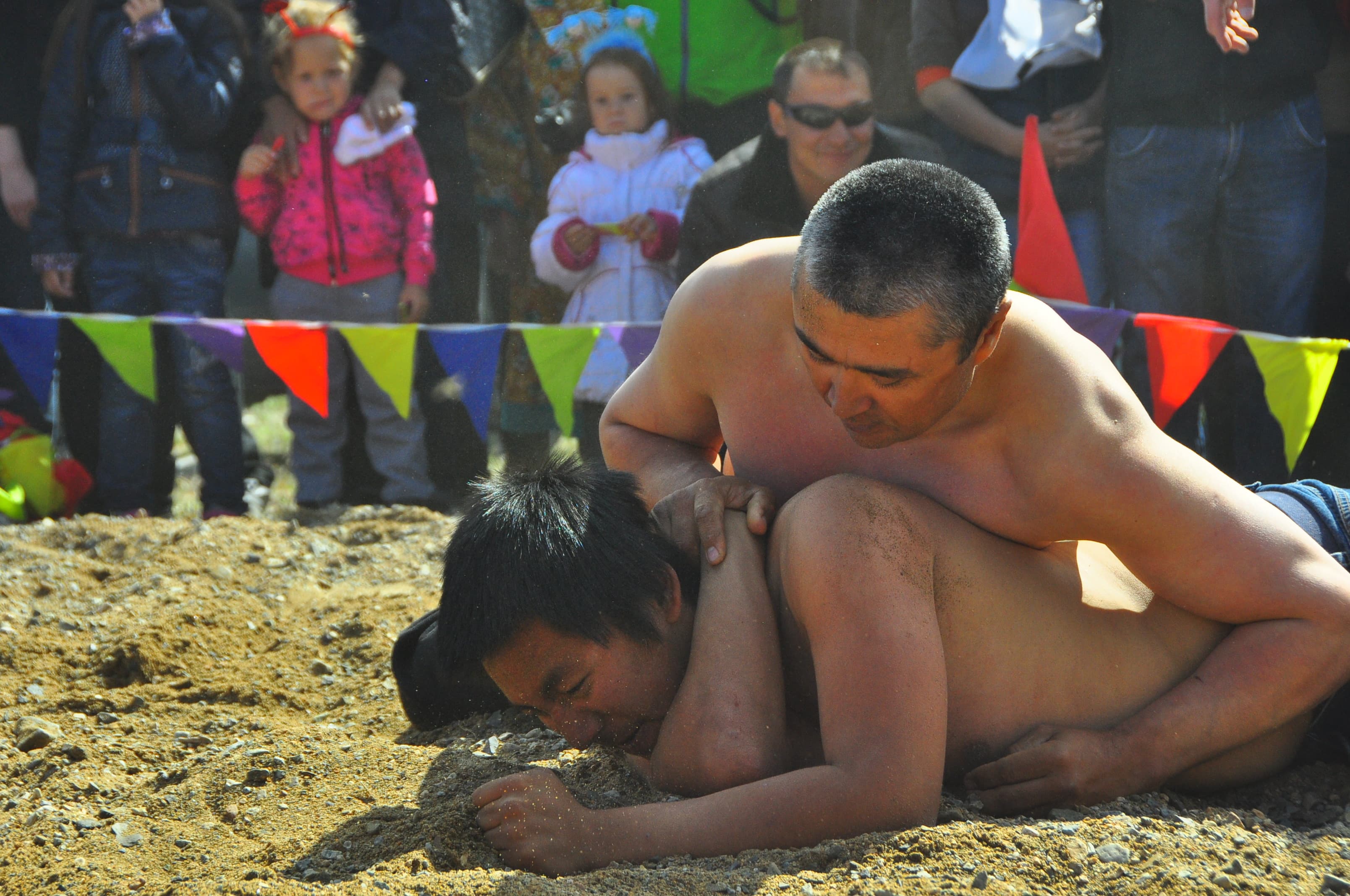 A Russian competitor pins his American counterpart during a wrestling match as part of the games.