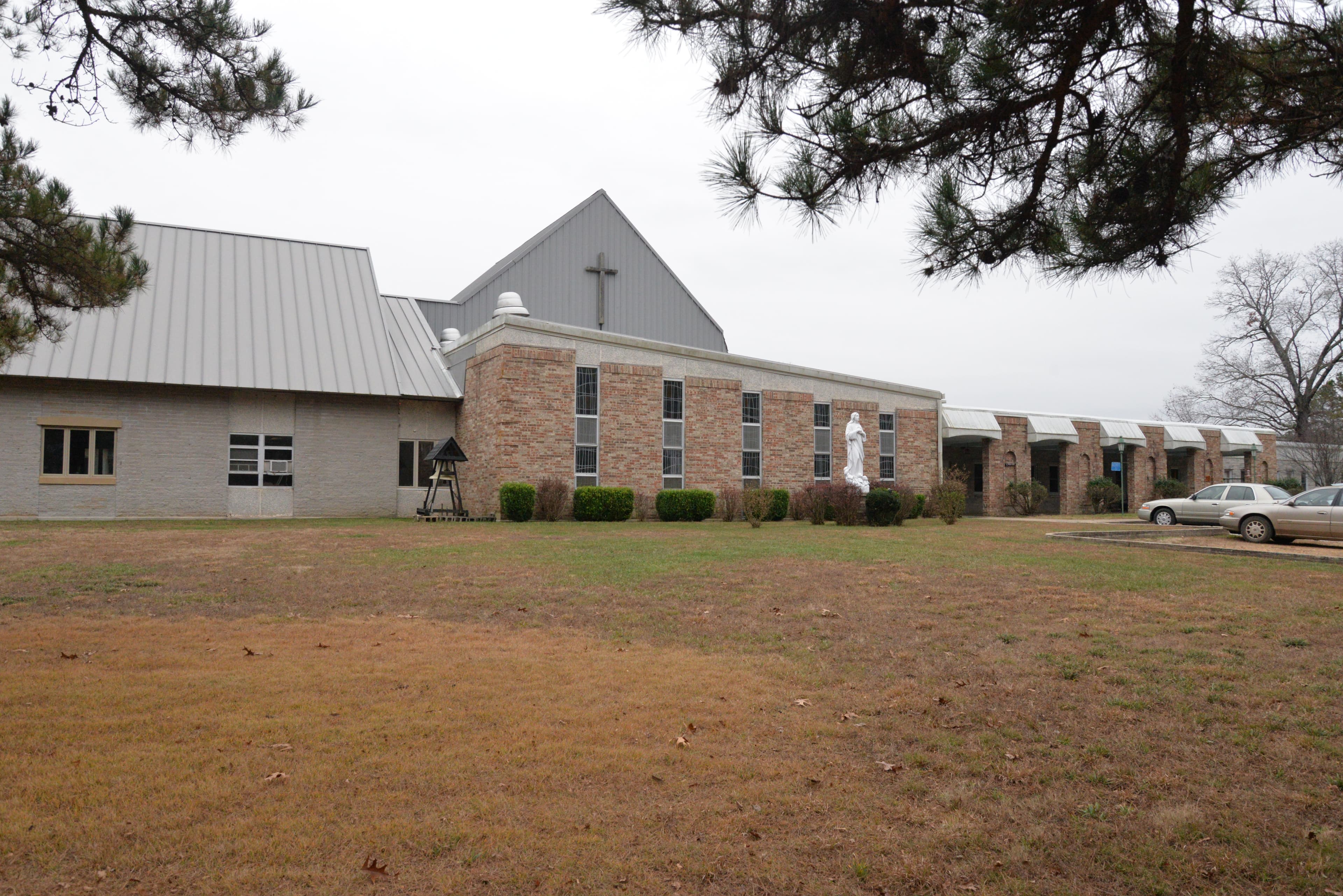 Simple building with cross at top, lawn in front