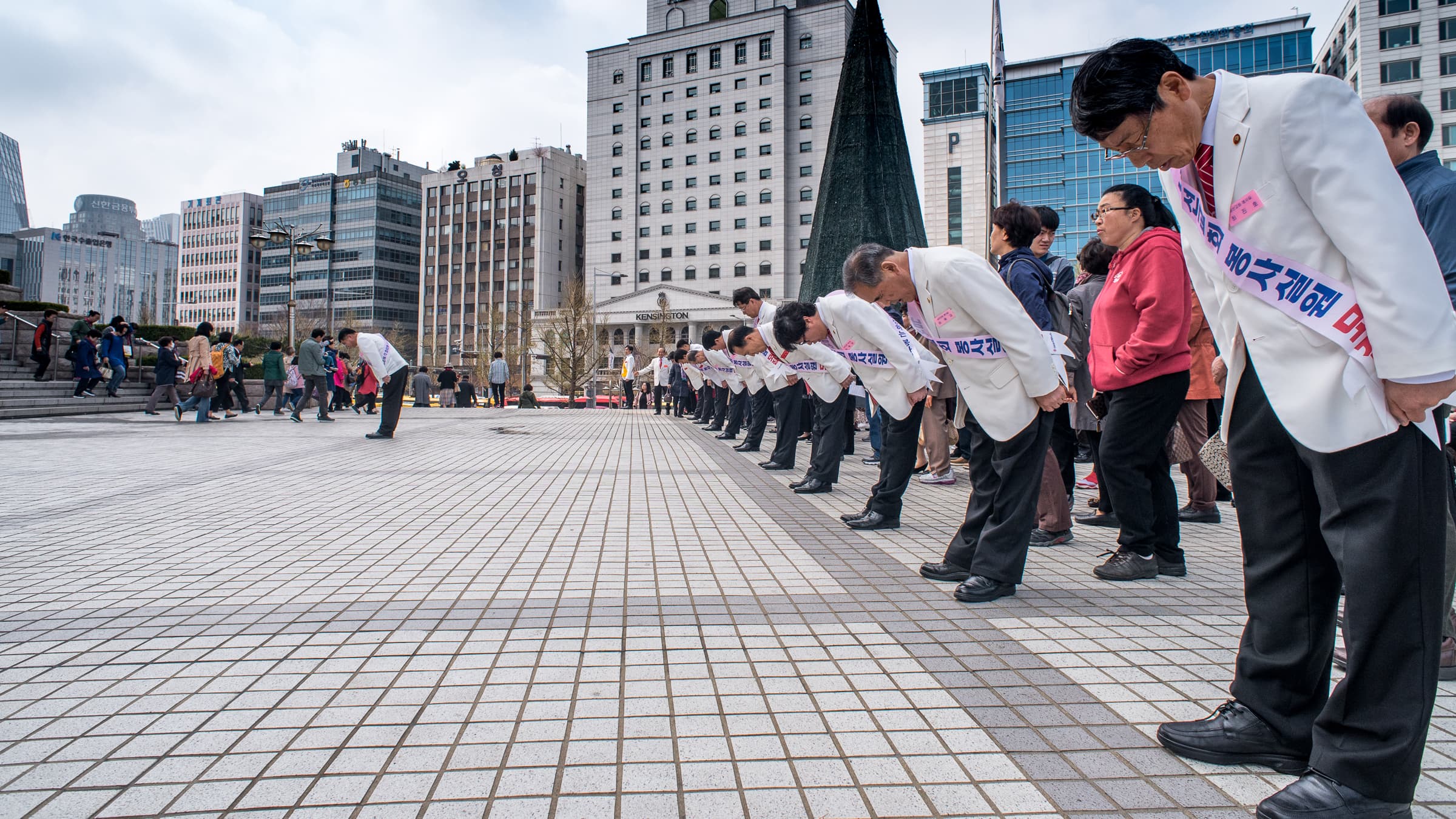 Ushers outside of a recent Sunday service at Yoido Full Gospel Church bow as worshippers begin to leave the church.