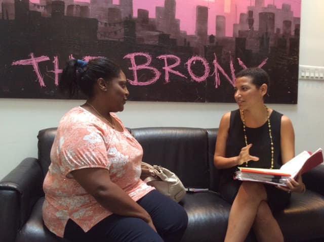 Two women sitting on sofa talking
