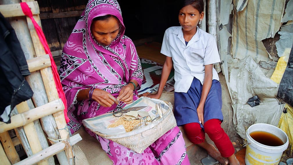 girl with woman rolling cigs