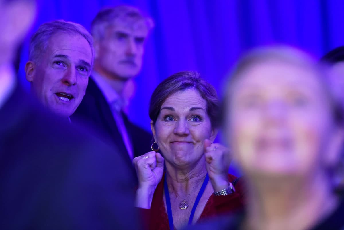 People react to the television coverage of US presidential election results during an election party at the US embassy in London.