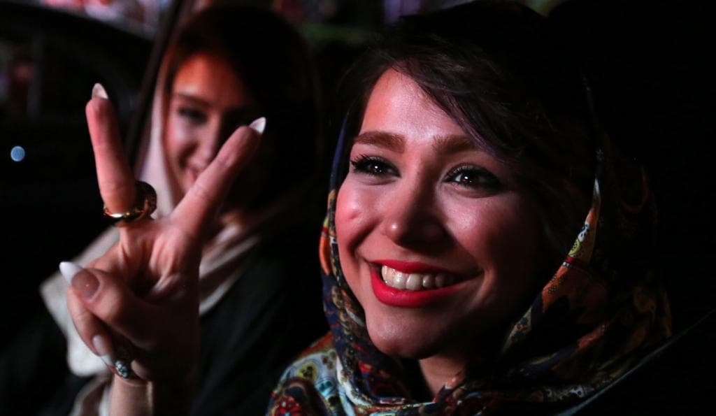 Iranian women flash the 'V' sign for victory during celebrations in northern Tehran on July 14, 2015, after Iran's nuclear negotiating team struck a deal with world powers in Vienna.