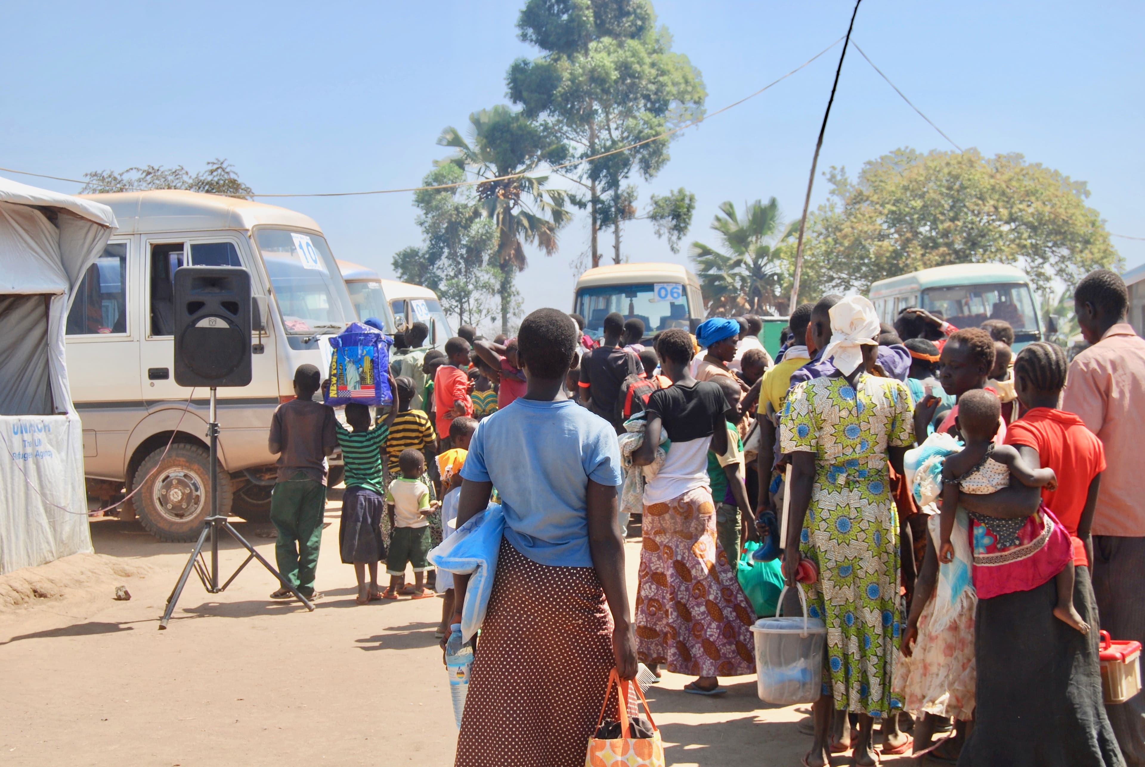 Newly arrived refugees from South Sudan wait to board buses at the Kuluba registration center in Uganda, just minutes from the border. From here, they will be taken to refugee settlements to begin their new lives.