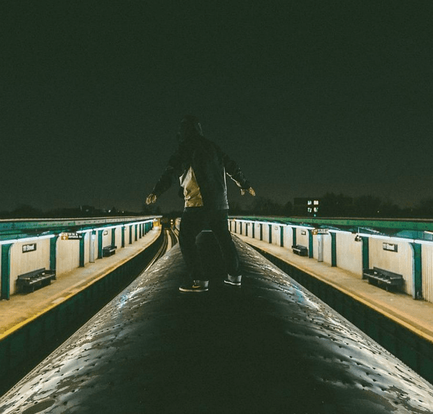 A photo of one of Deas' friends surfing a subway train.