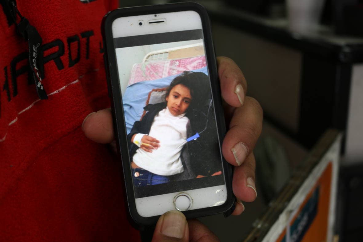 Askar speaks with his 10-year-old daughter