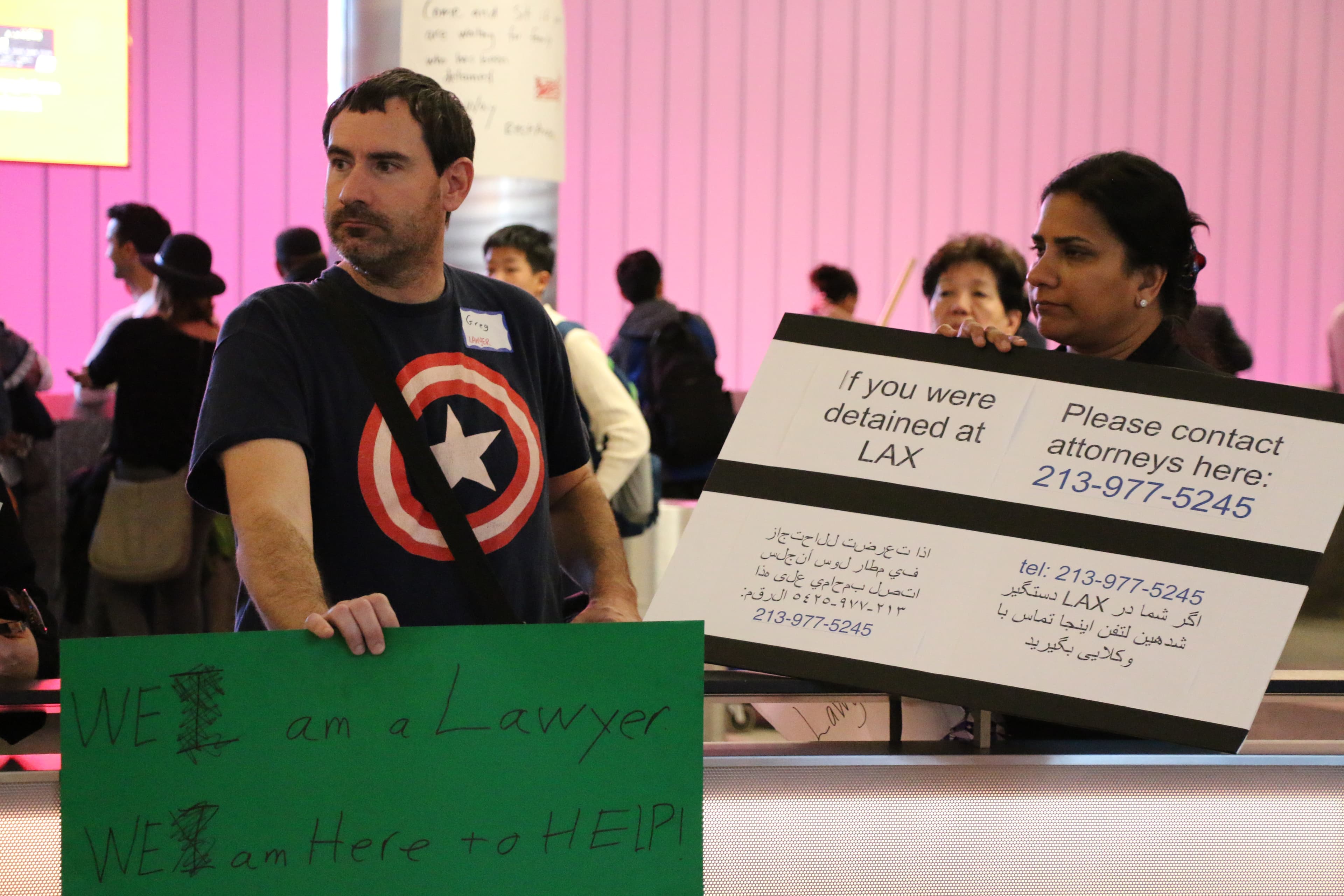 Lawyers hold signs offering assistance