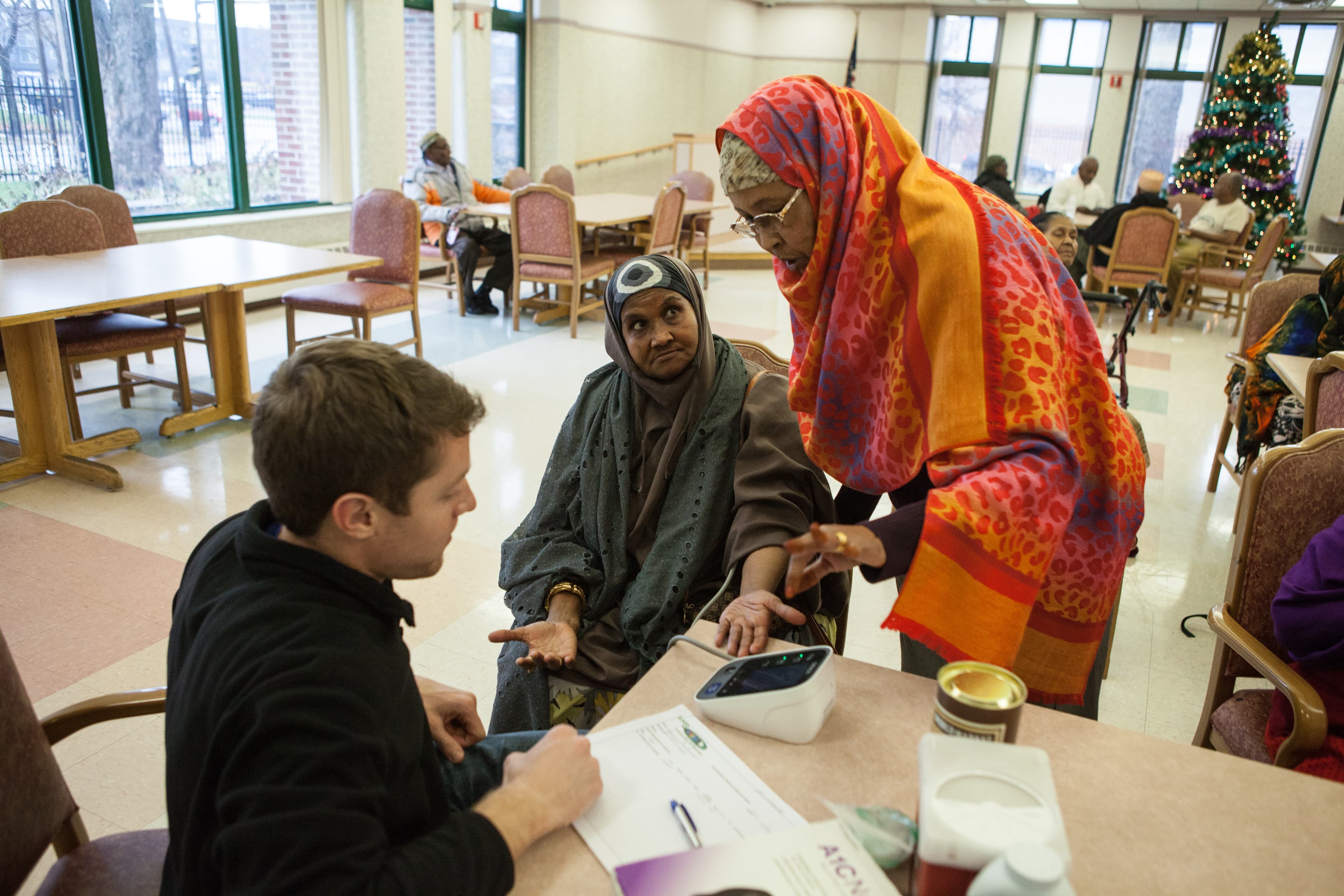 Women around table get blood pressure checked