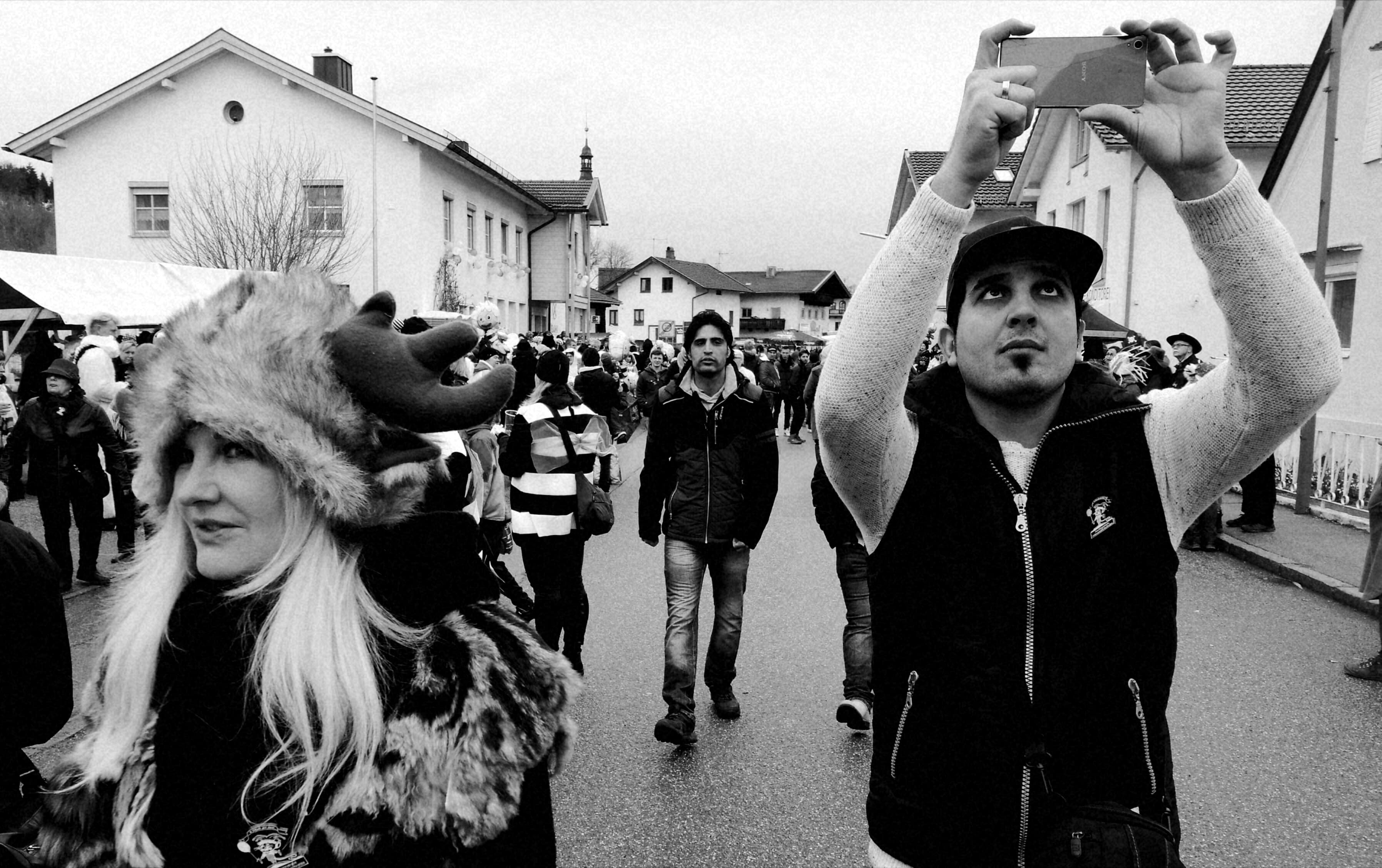 Ali Daas takes photos during Carnival in Altenmarkt, Bavaria.