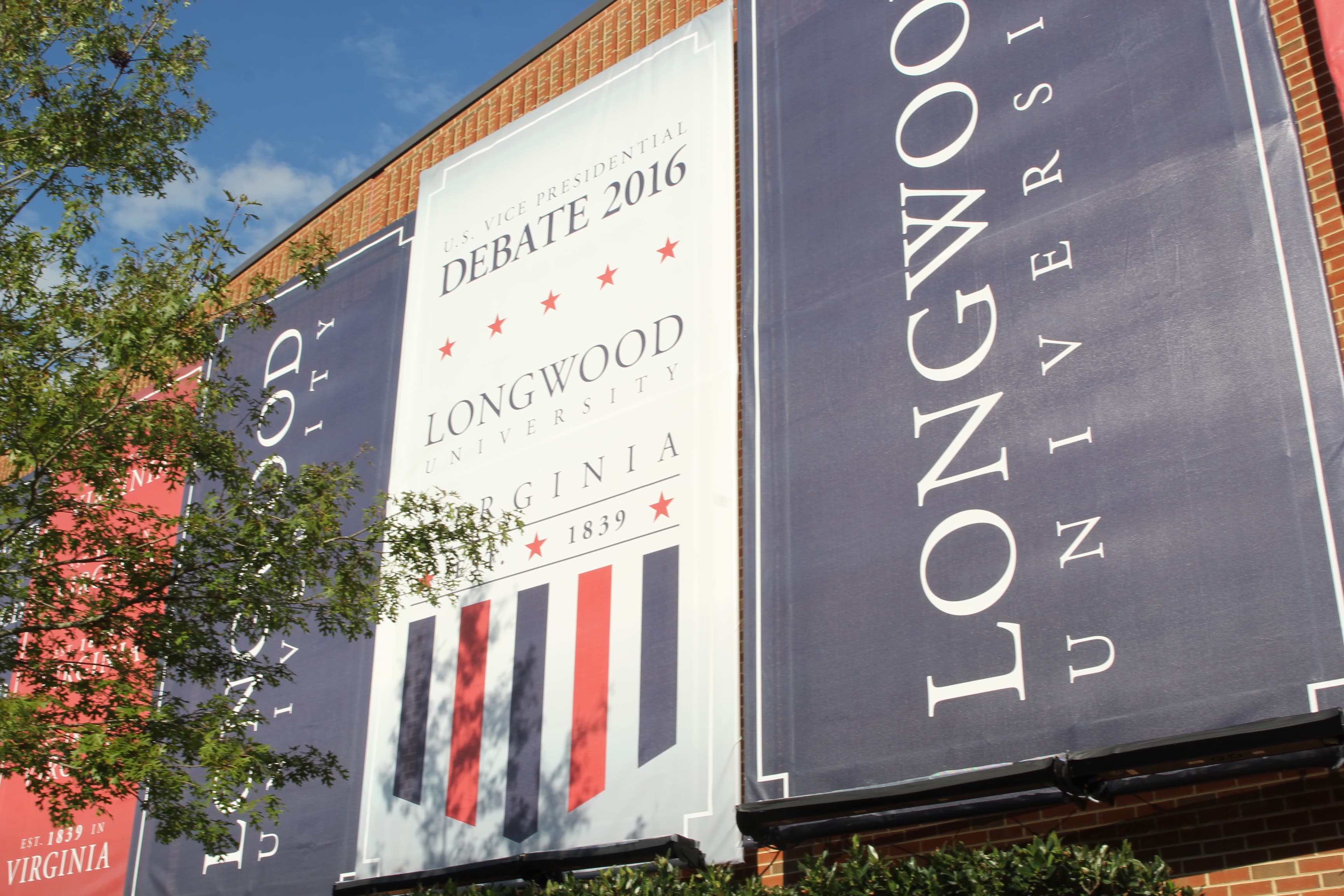 Signs outside Longwood University's debate hall.