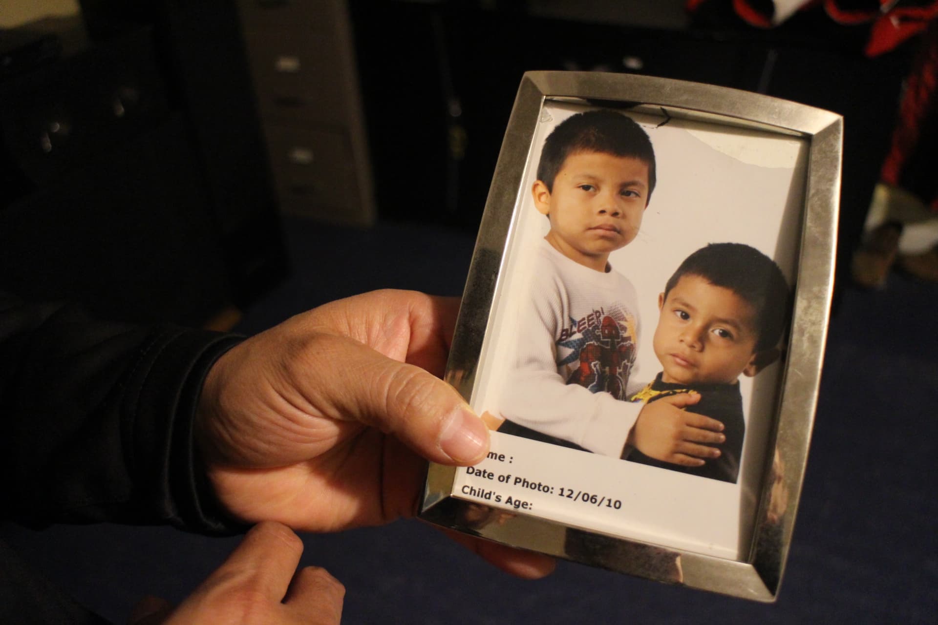 This photo of Calel's sons is on display in his living room. At the time of this interview, he hadn't seen them in a few months.