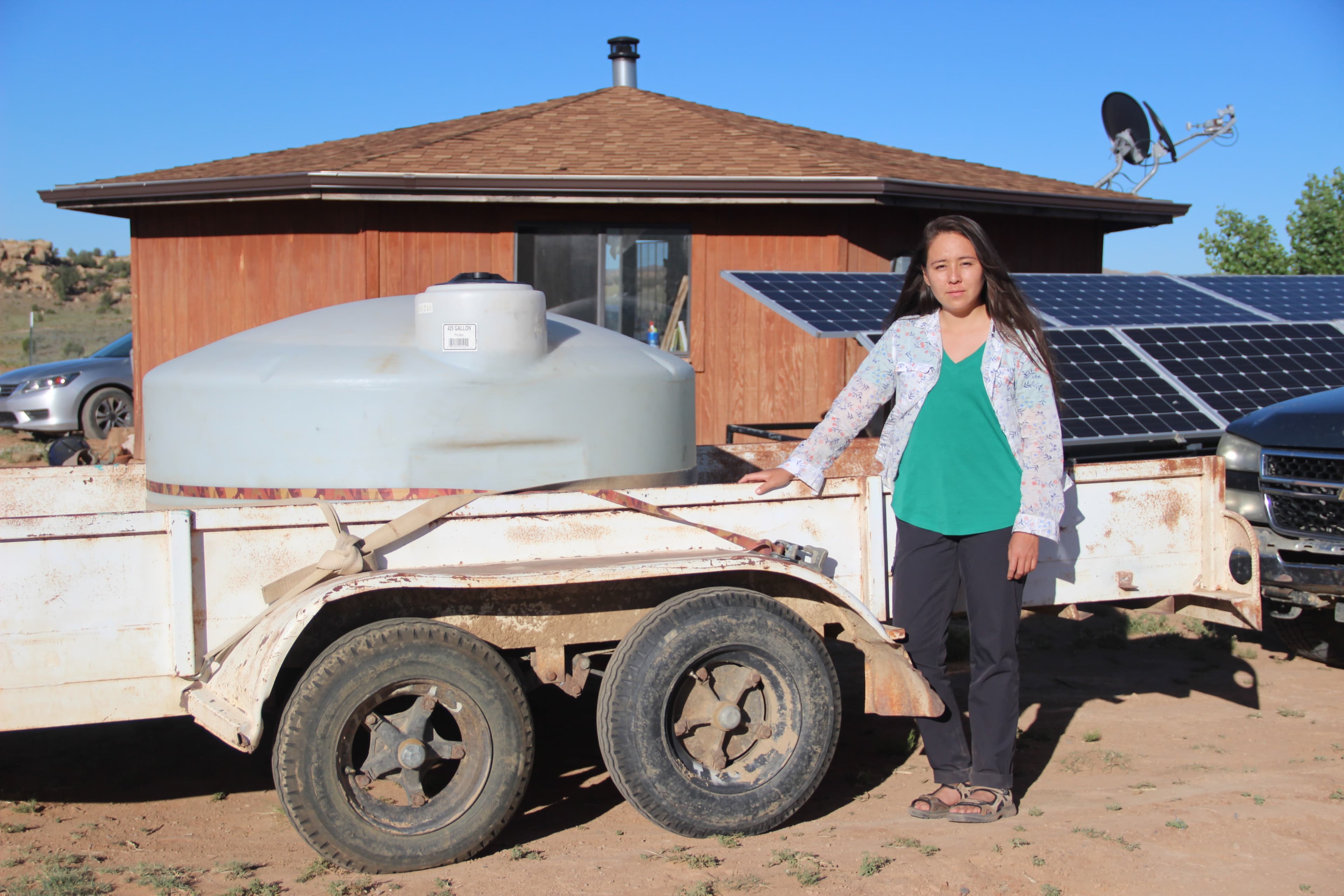 Woman in front of water tank