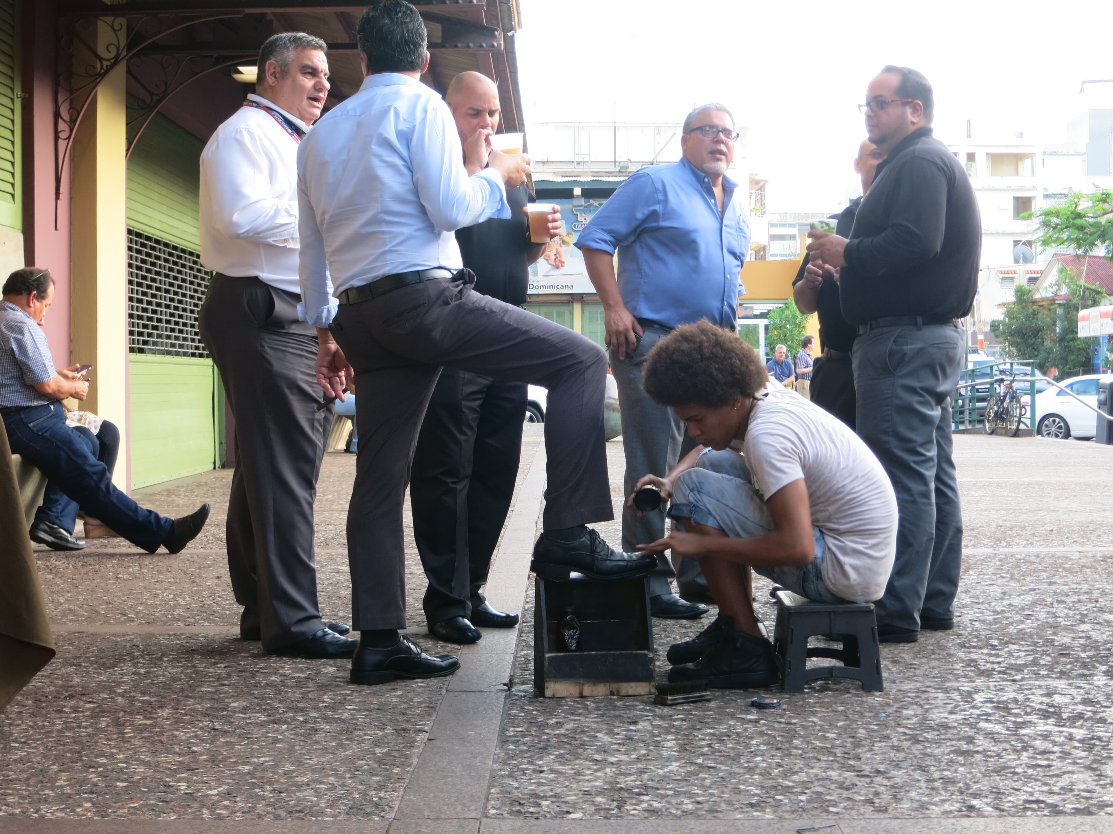 A group of men gather after work in a central square in San Juan's Santurce neighborhood.