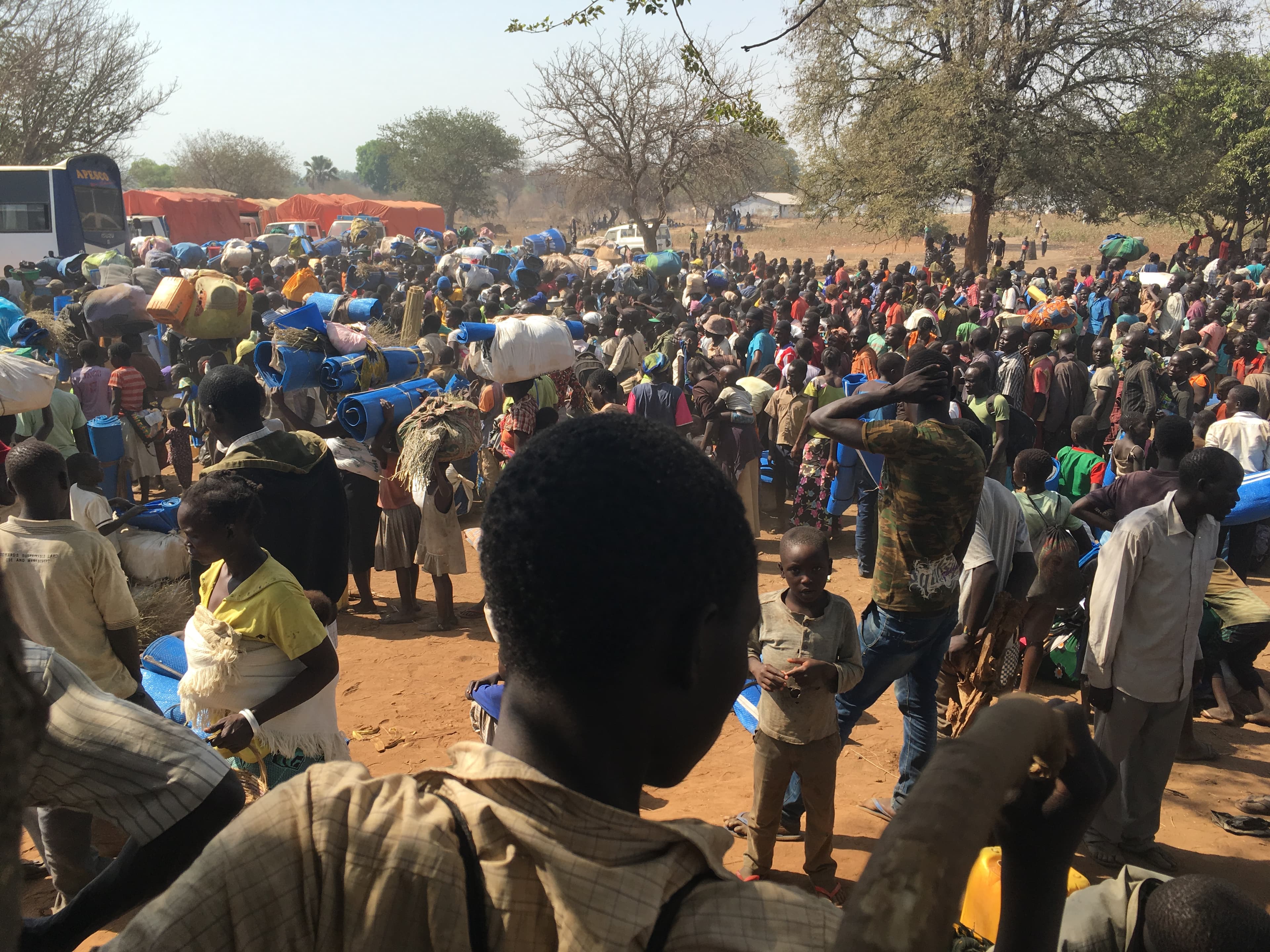 Refugees board buses at the Palorinya reception center on their way to their resettlement zones.