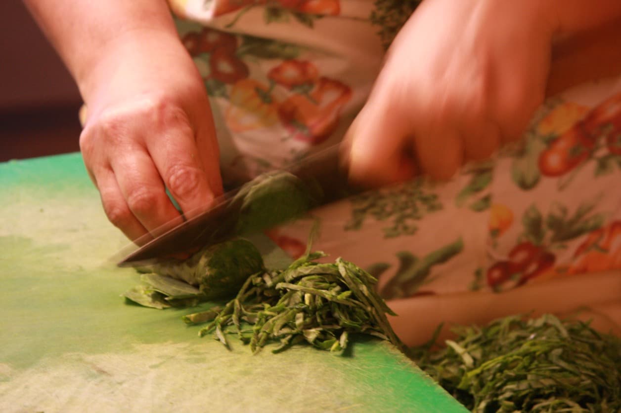 A sous-chef chops collard greens in the kitchen of .Org Bistro in Rio.