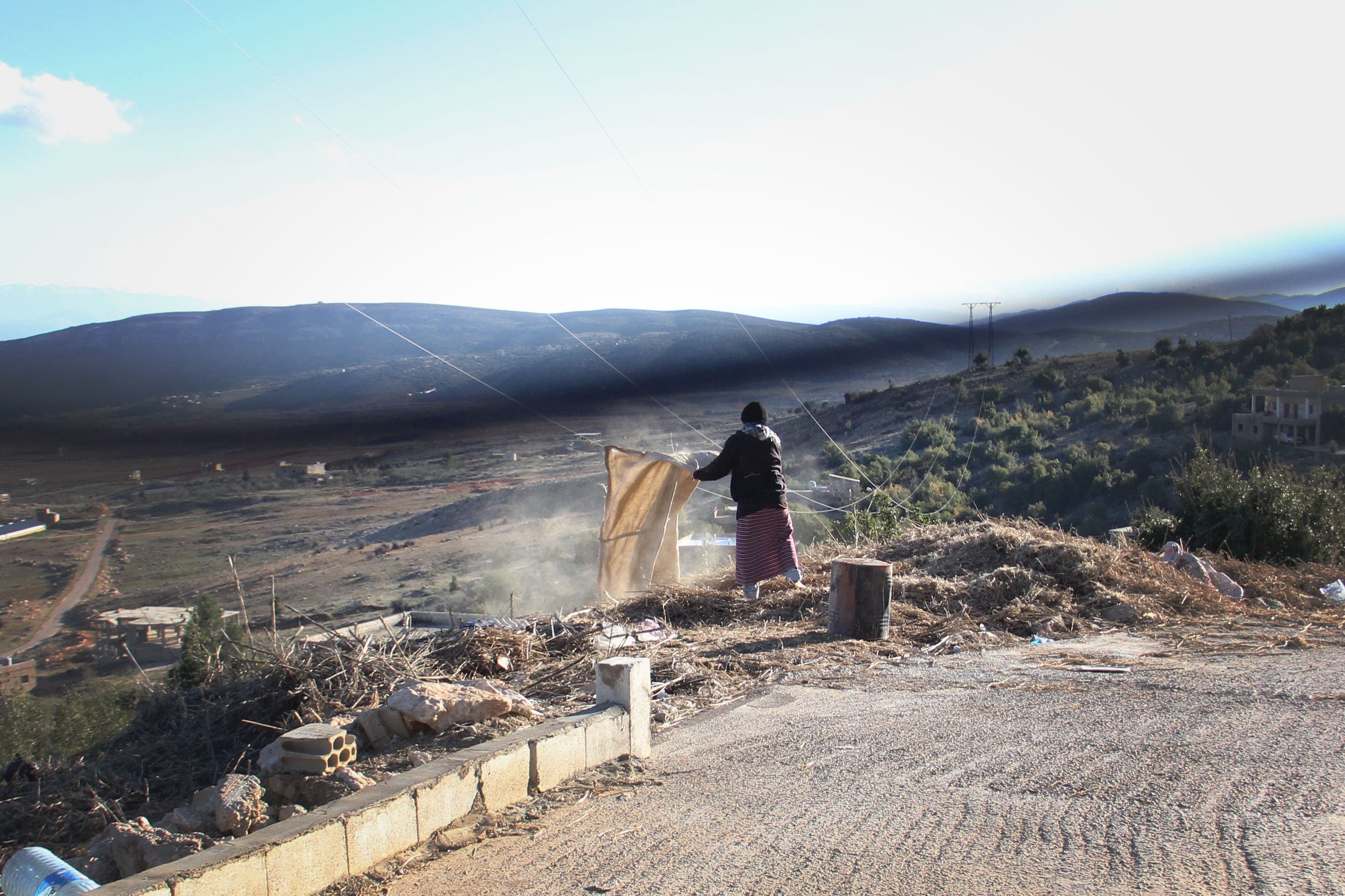 A hashish factory worker in Bouday, in Lebanon’s Bekaa Valley, shakes cannabis dust from a bag. Bouday is roughly 30 minutes from the Syrian border, and drug lords here say they're ready to defend their turf, and local villages, against any incursions by