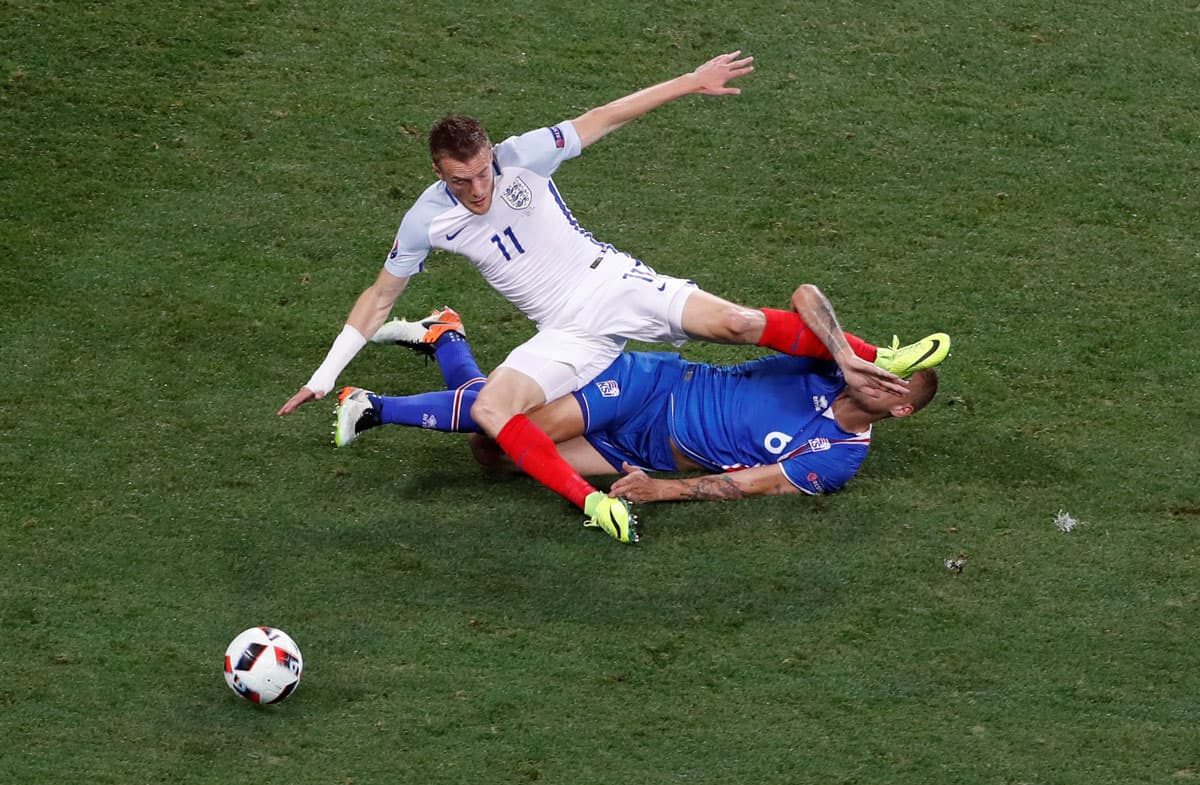 Iceland's Ragnar Sigurdsson in action with England's Jamie Vardy.