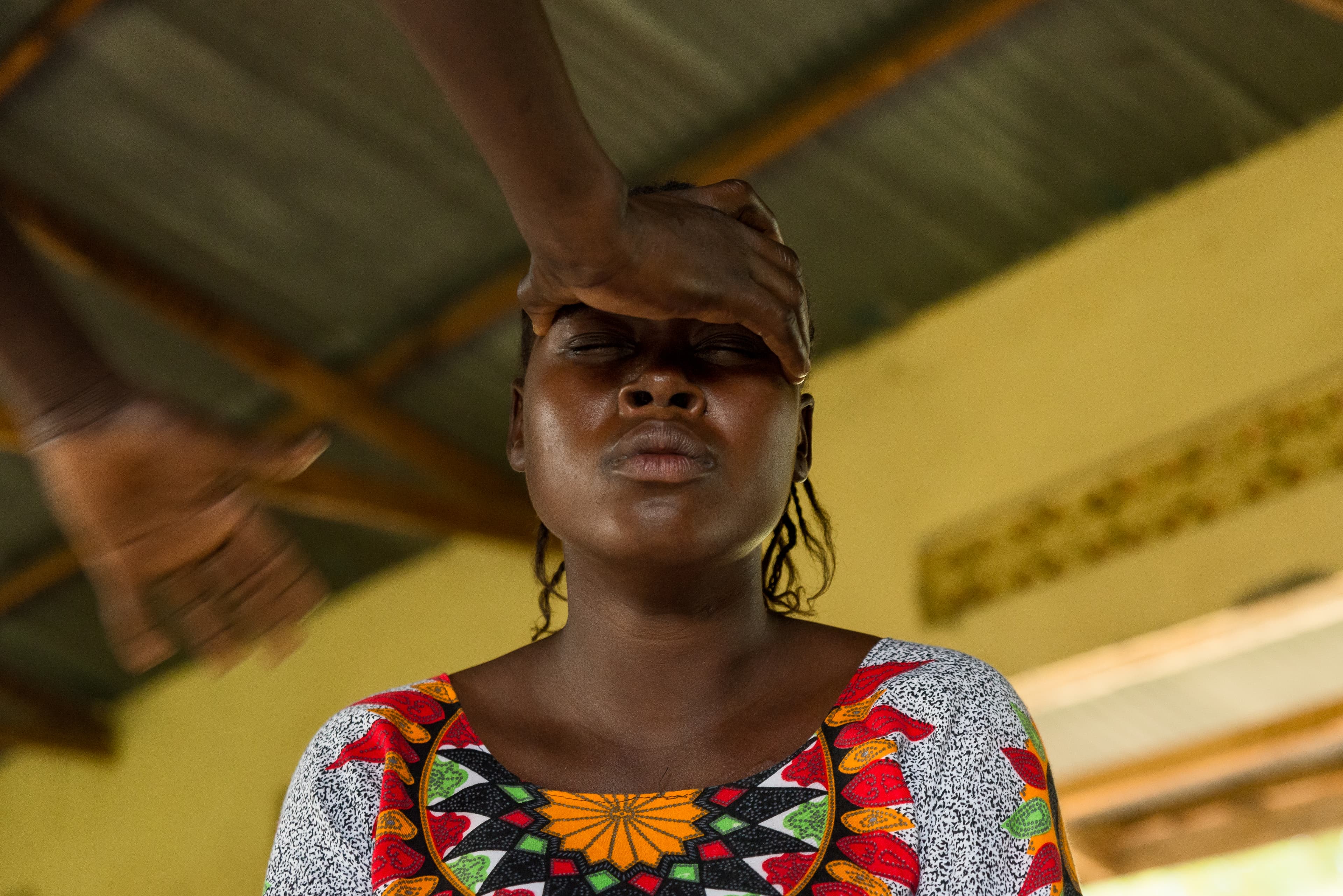 Jacqueline receives a blessing from her minister after finding a two-headed snake on her doorstep earlier that week.
