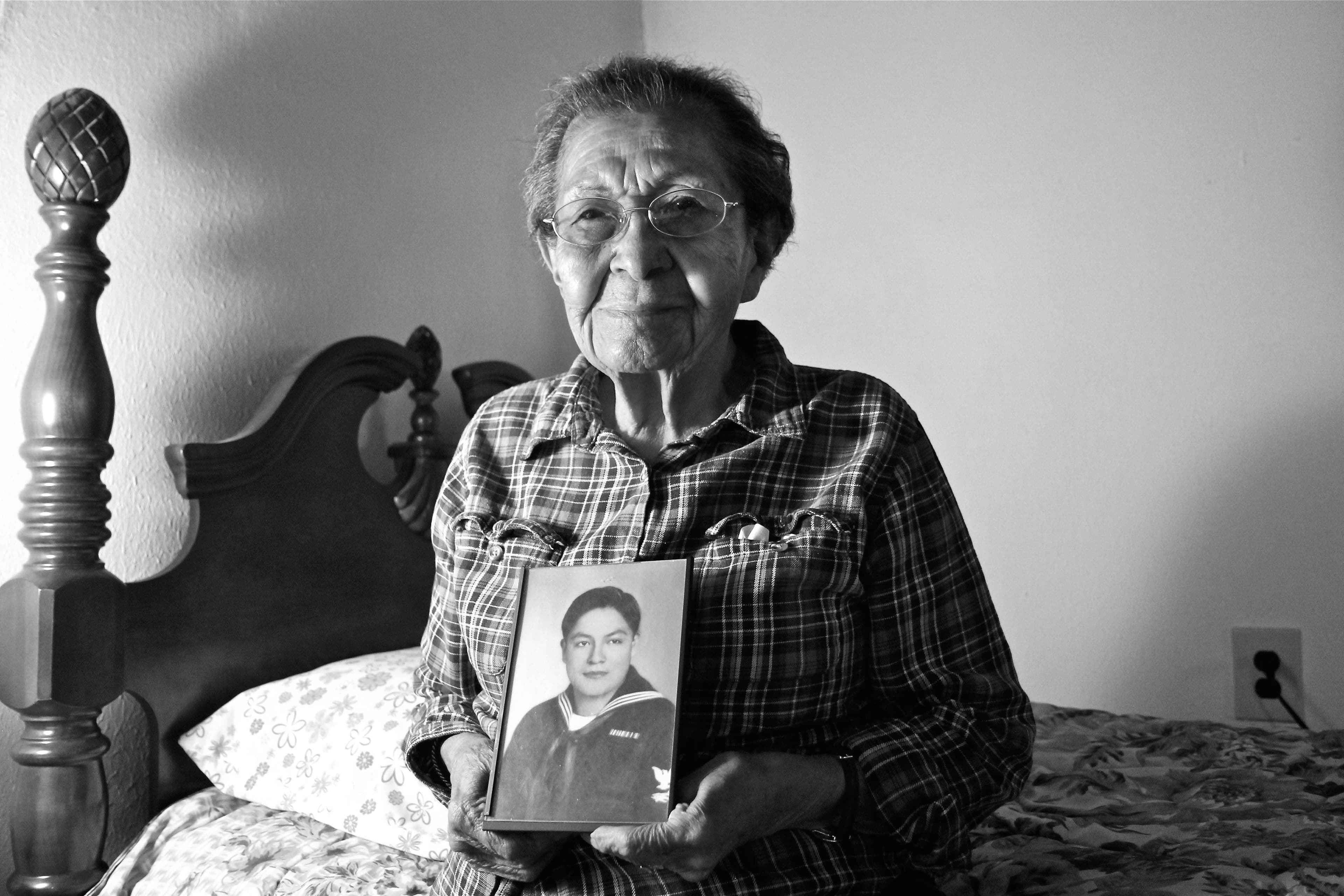 June Sarracino holding a photo of her husband Larry.