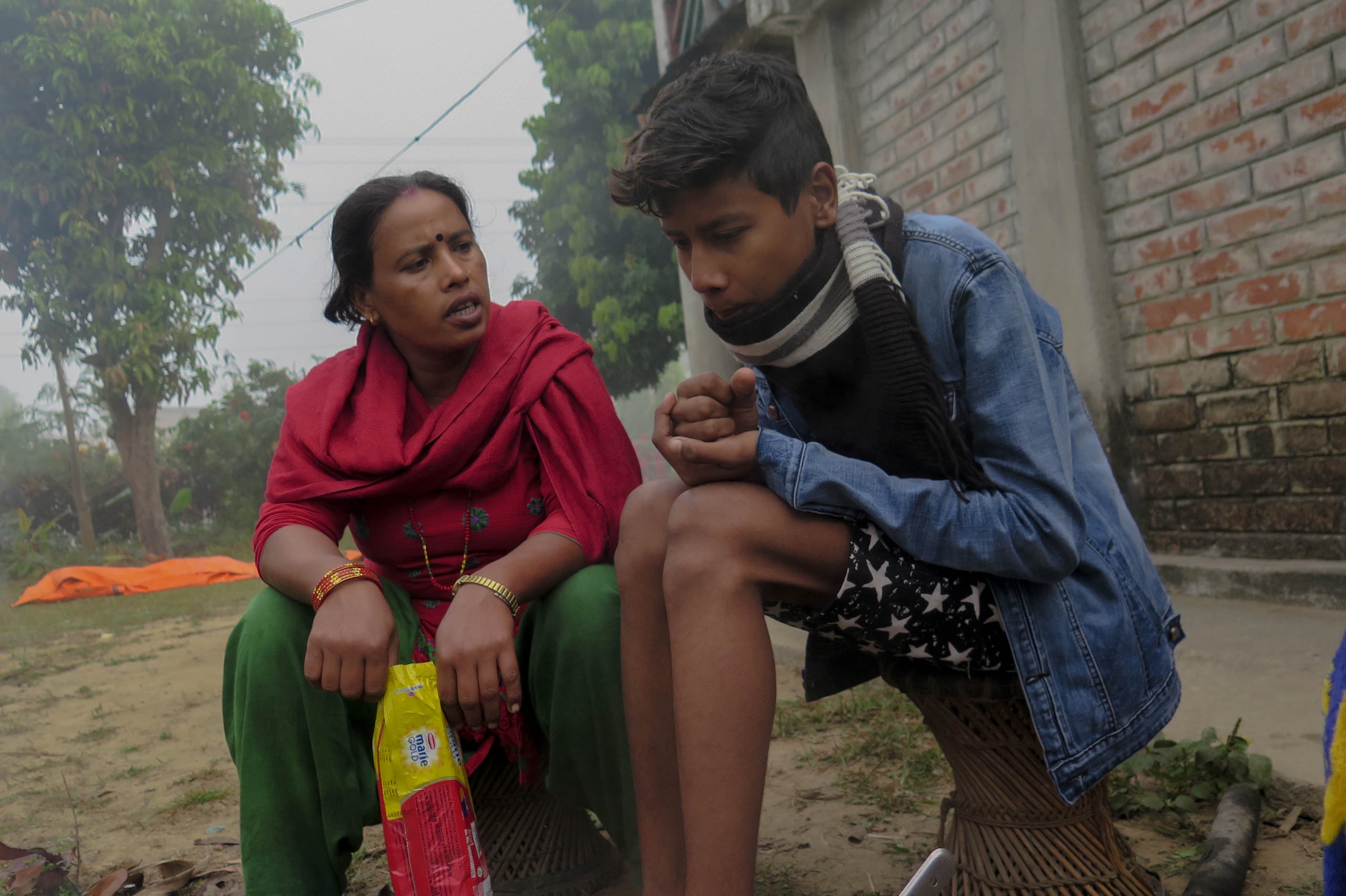 Woman and her son sit together at home