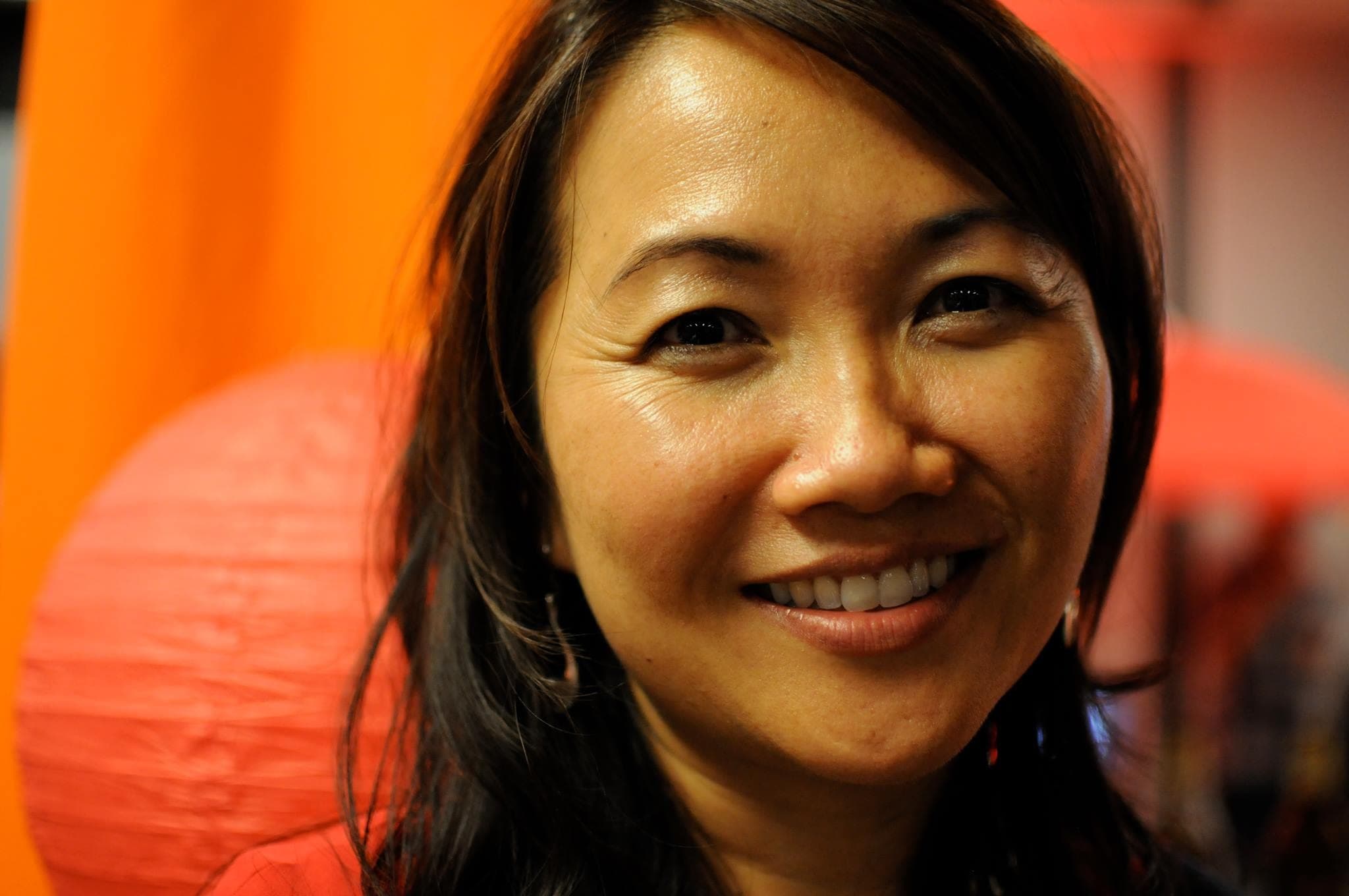 Woman's face against orange backdrop